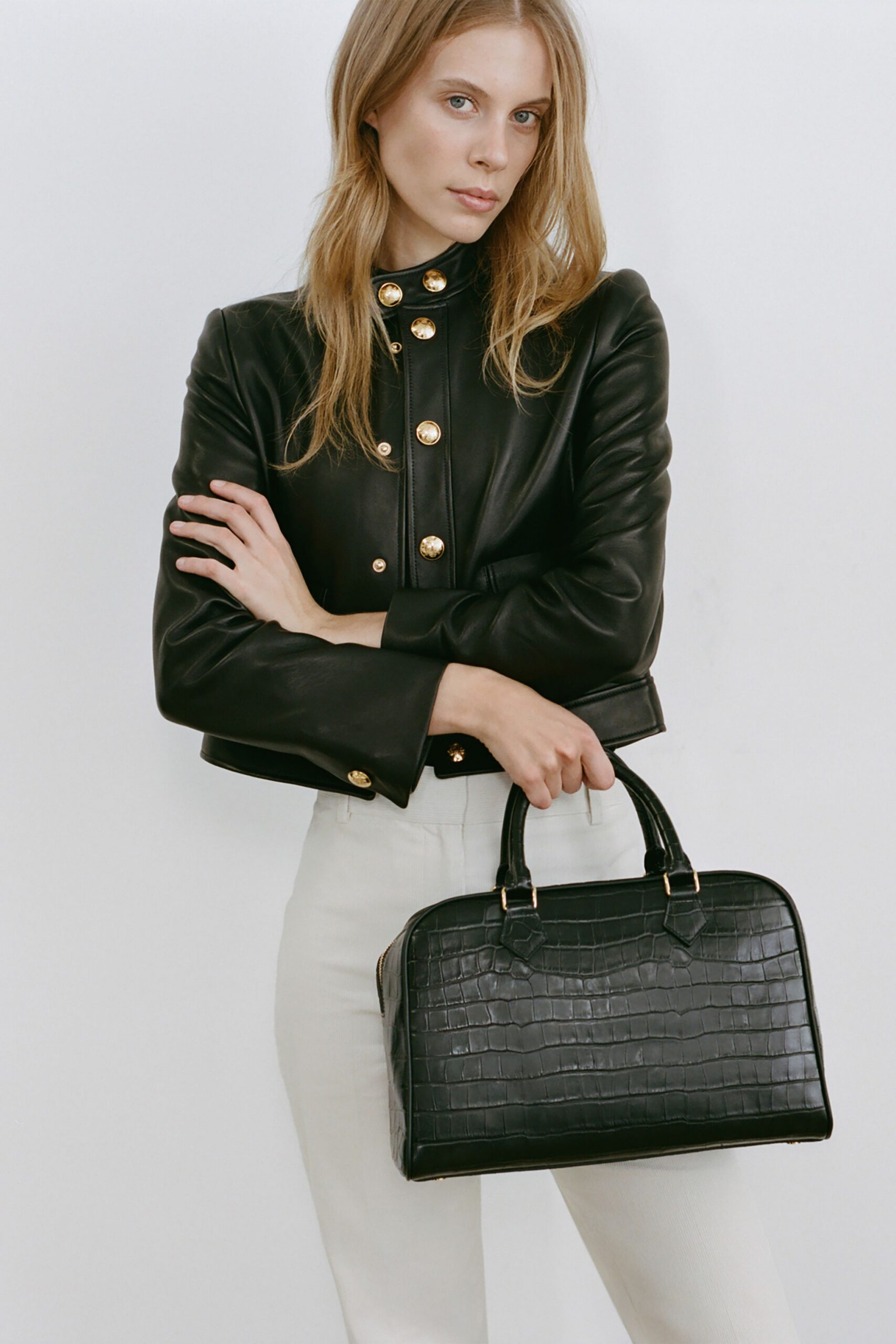 black leather fitted jacket with white pants