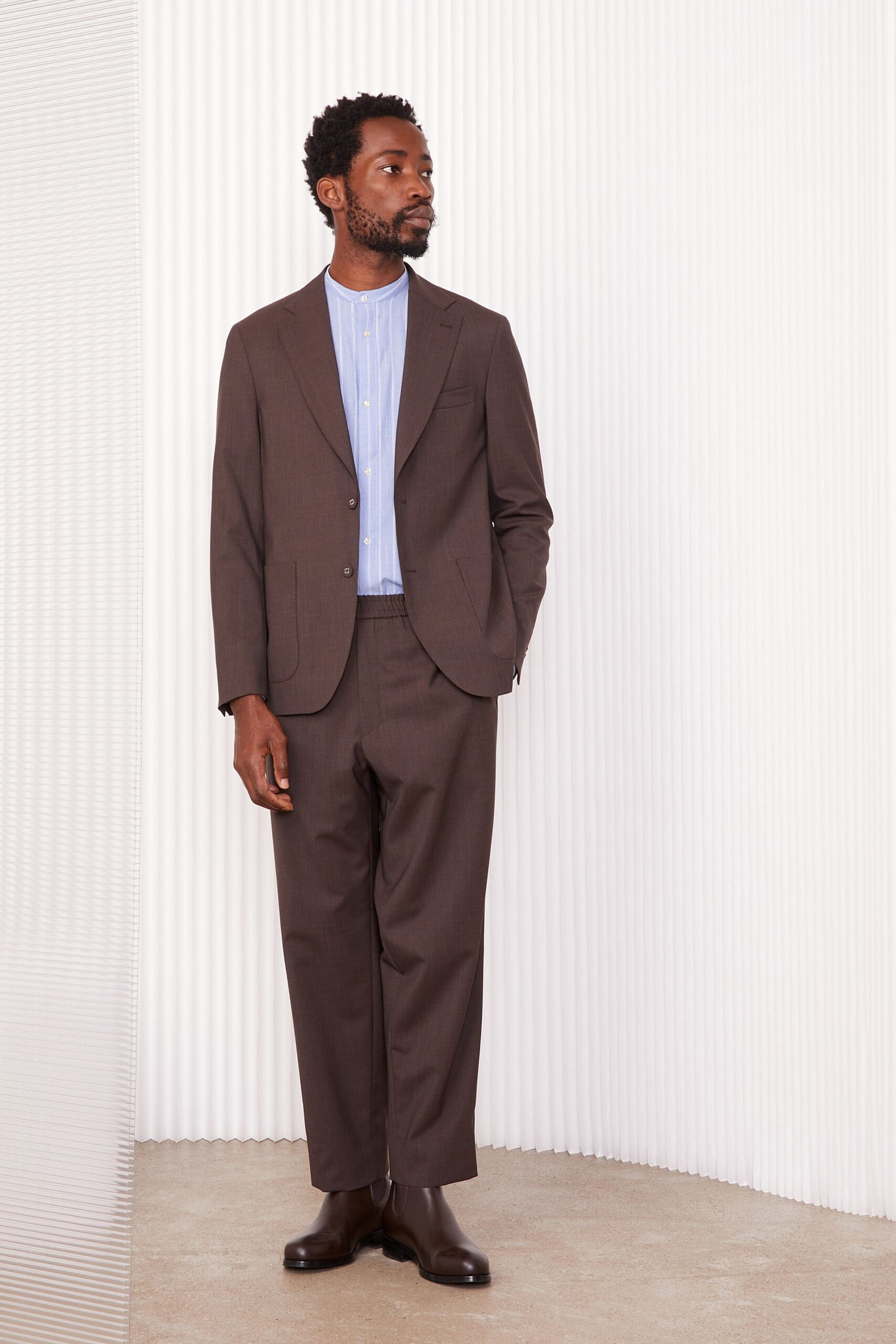 brown tailored suit with blue shirt