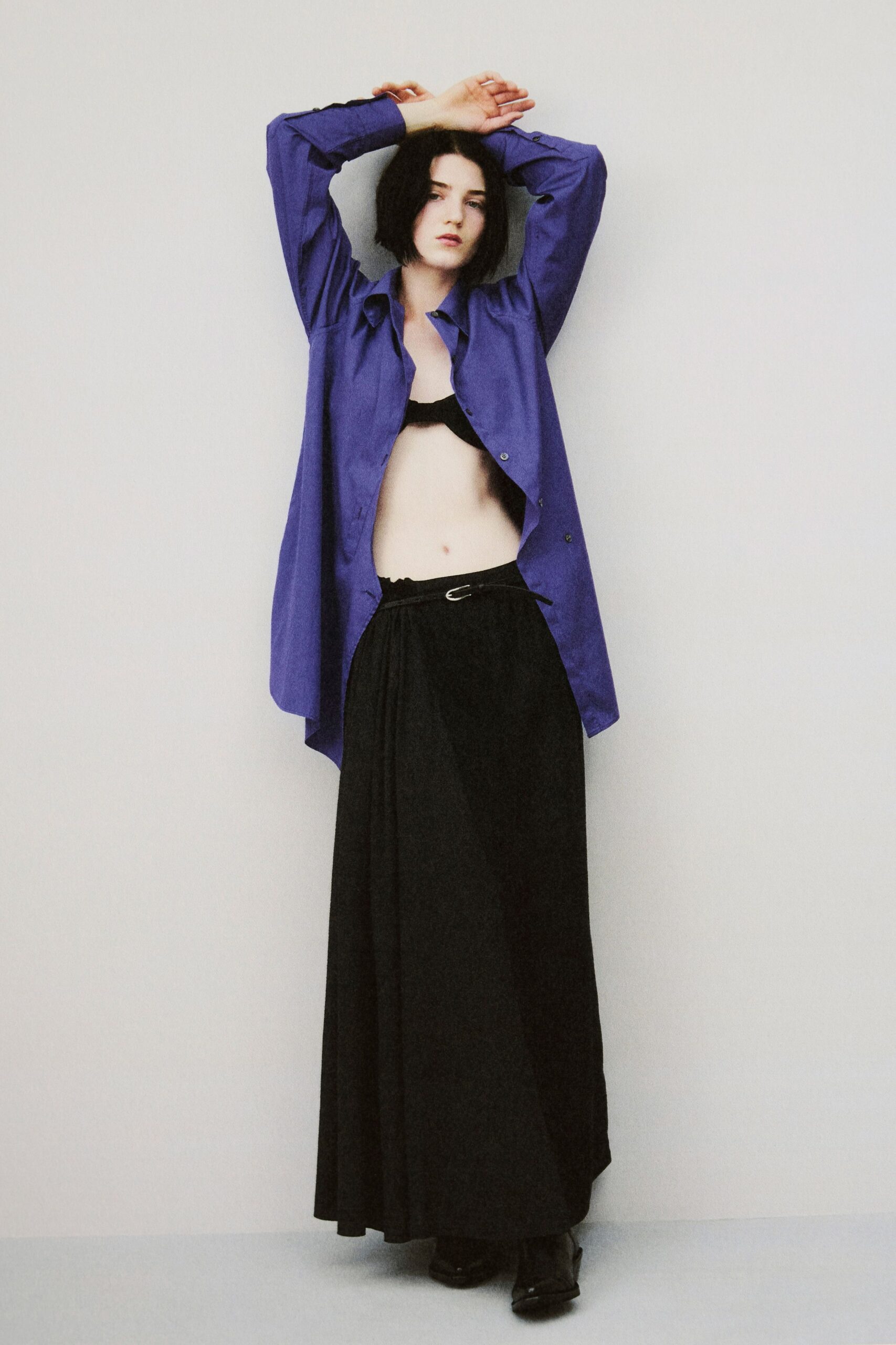 purple shirt black pleated skirt