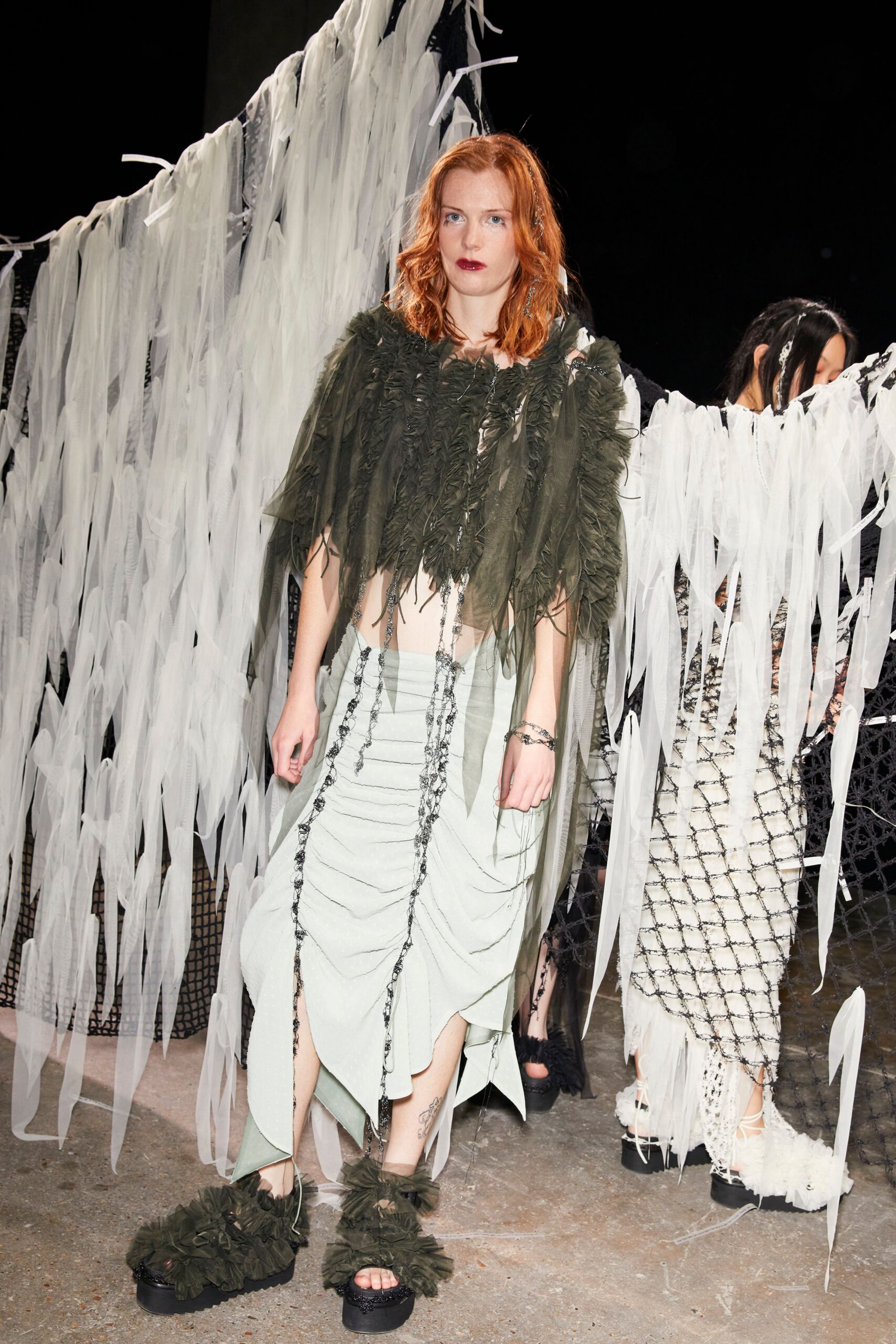 green fringed top gray skirt