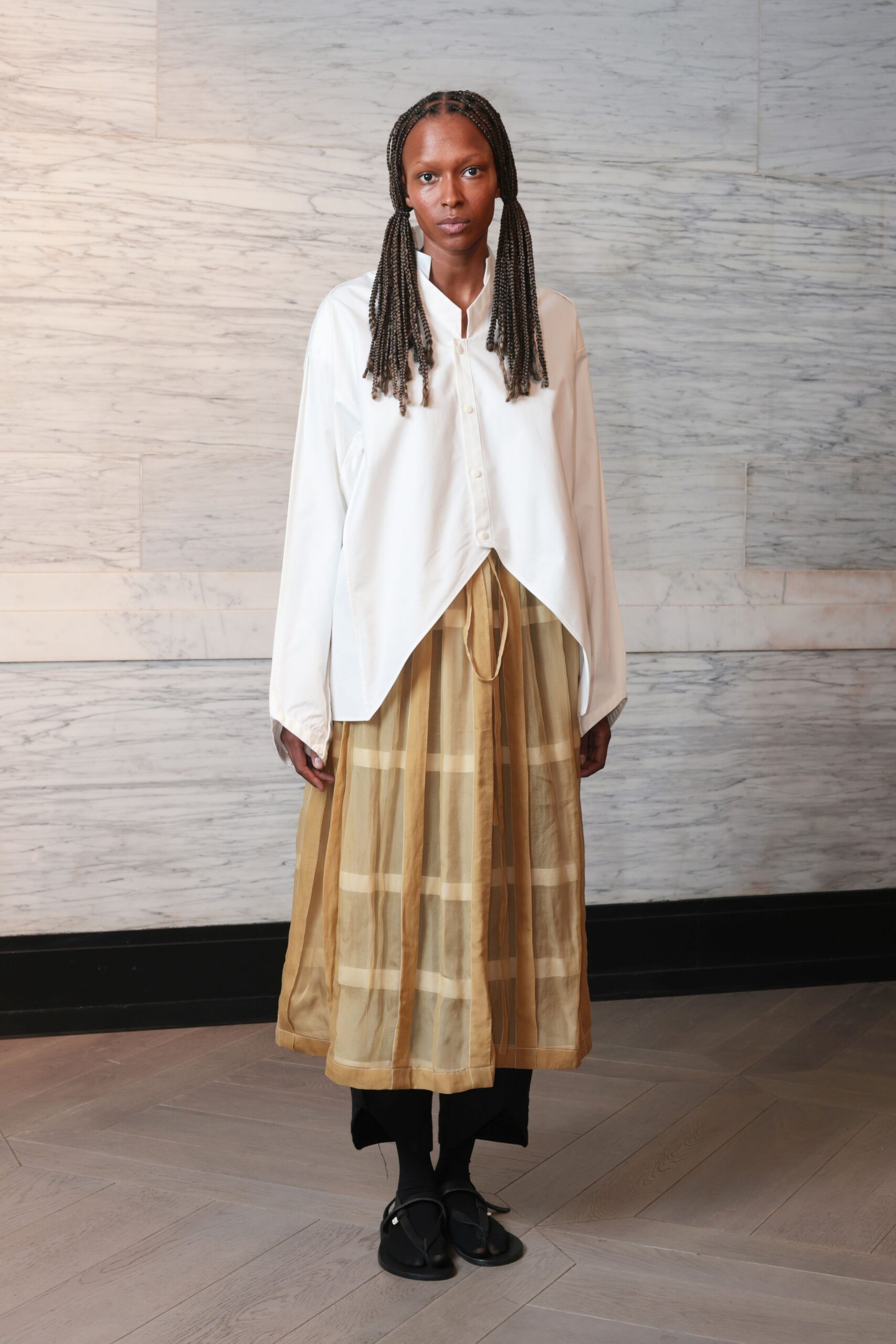 white relaxed shirt with gold pleated skirt