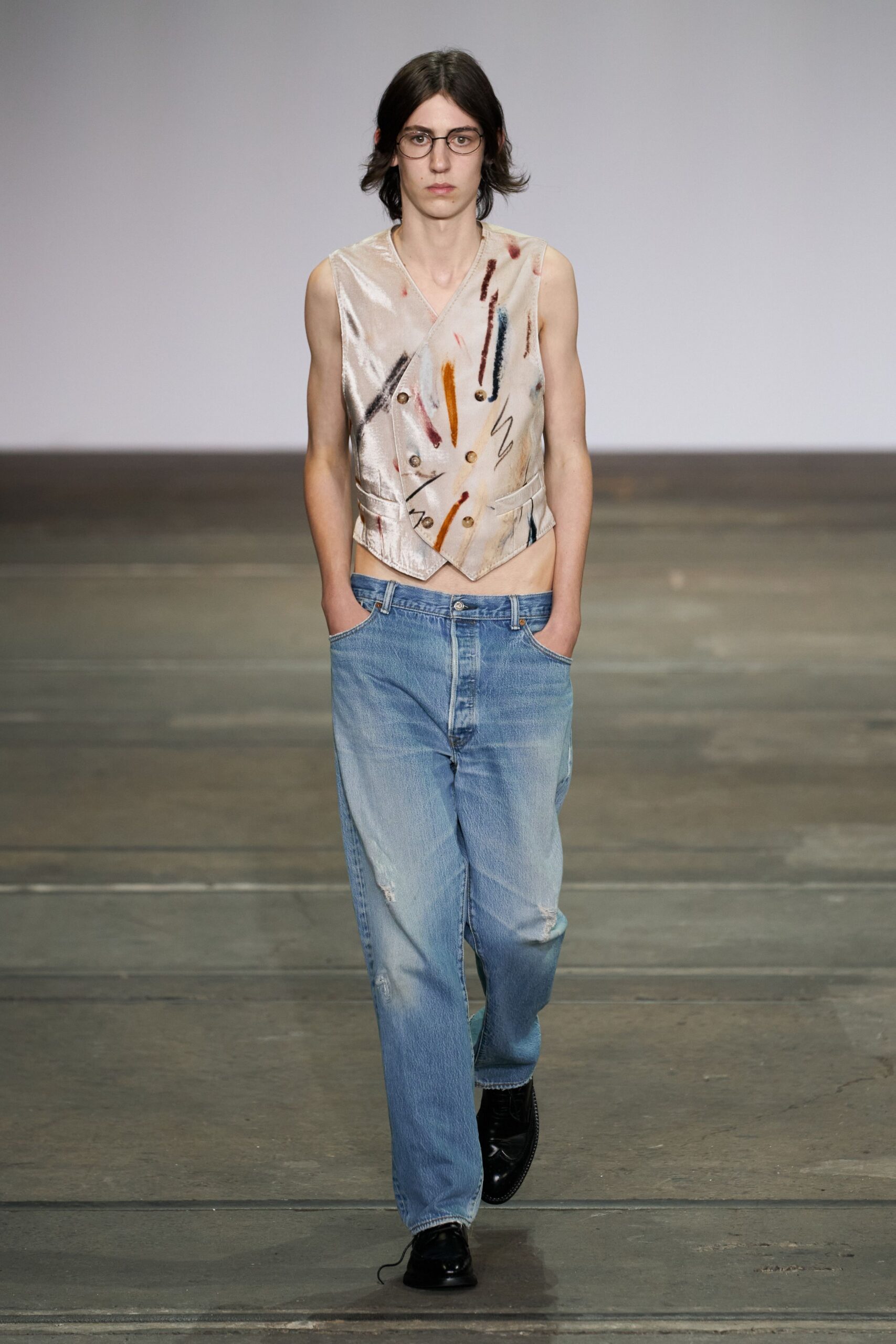 beige embroidered sleeveless top with jeans