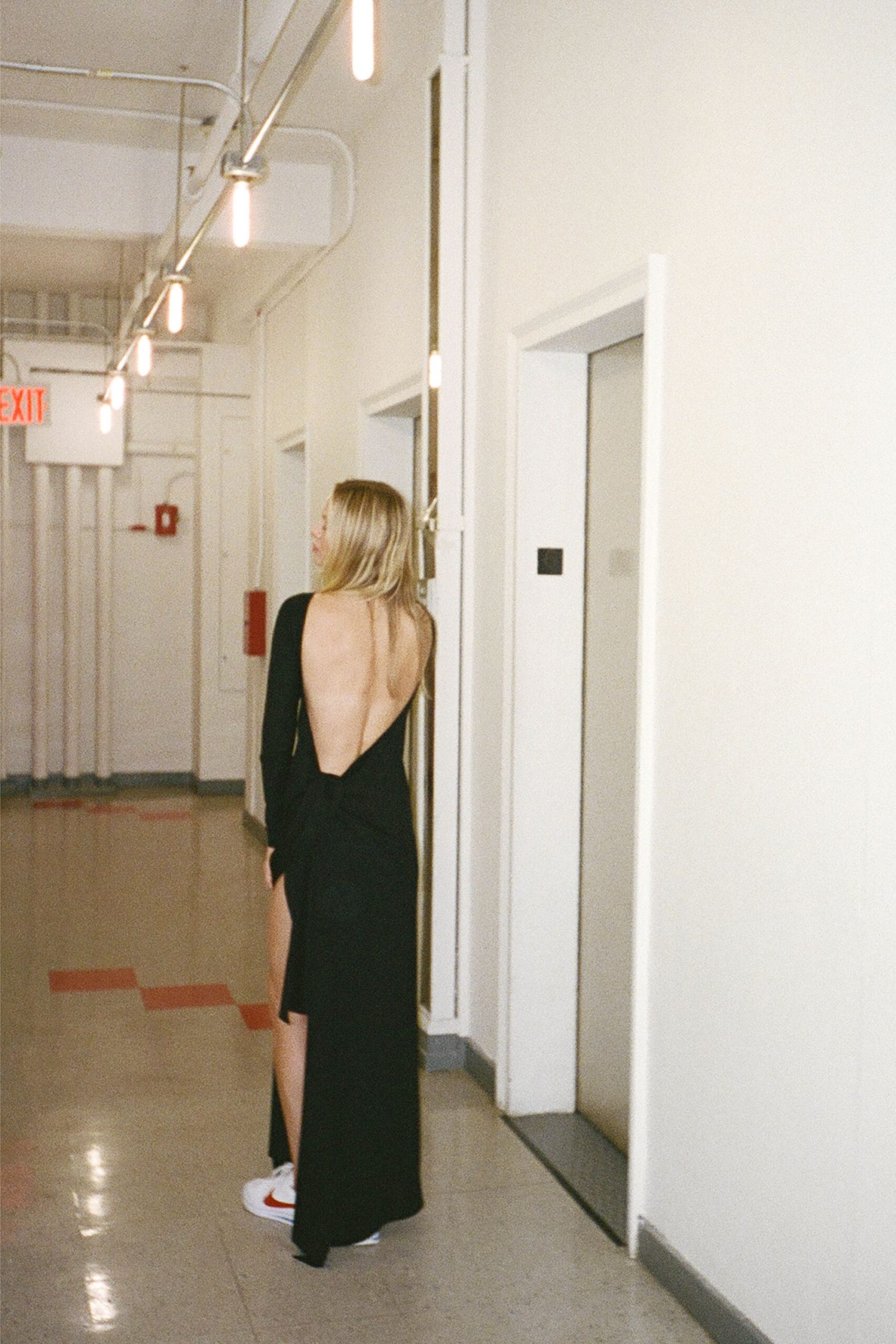 black backless maxi dress with white shoes