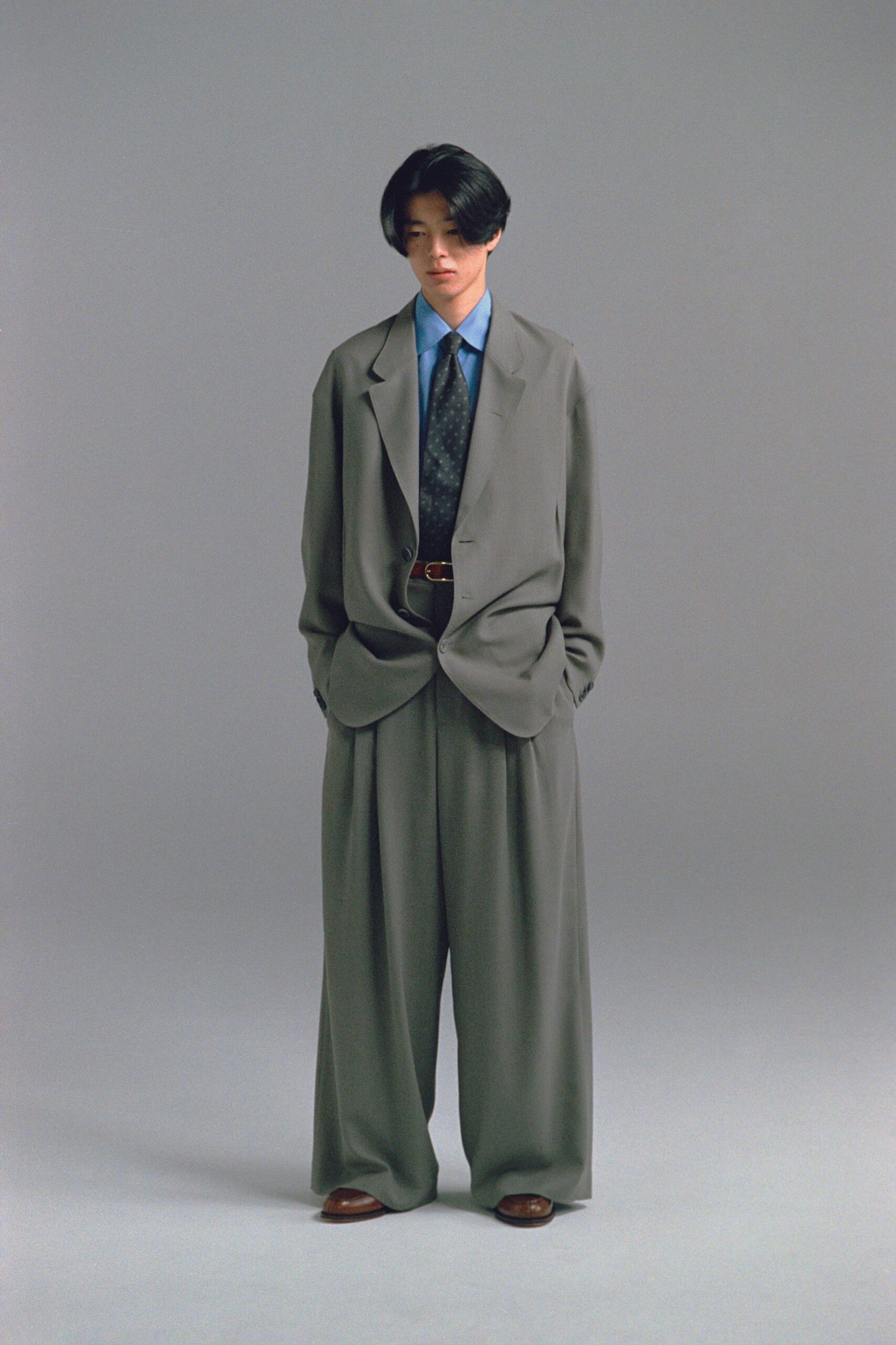gray relaxed suit with blue shirt