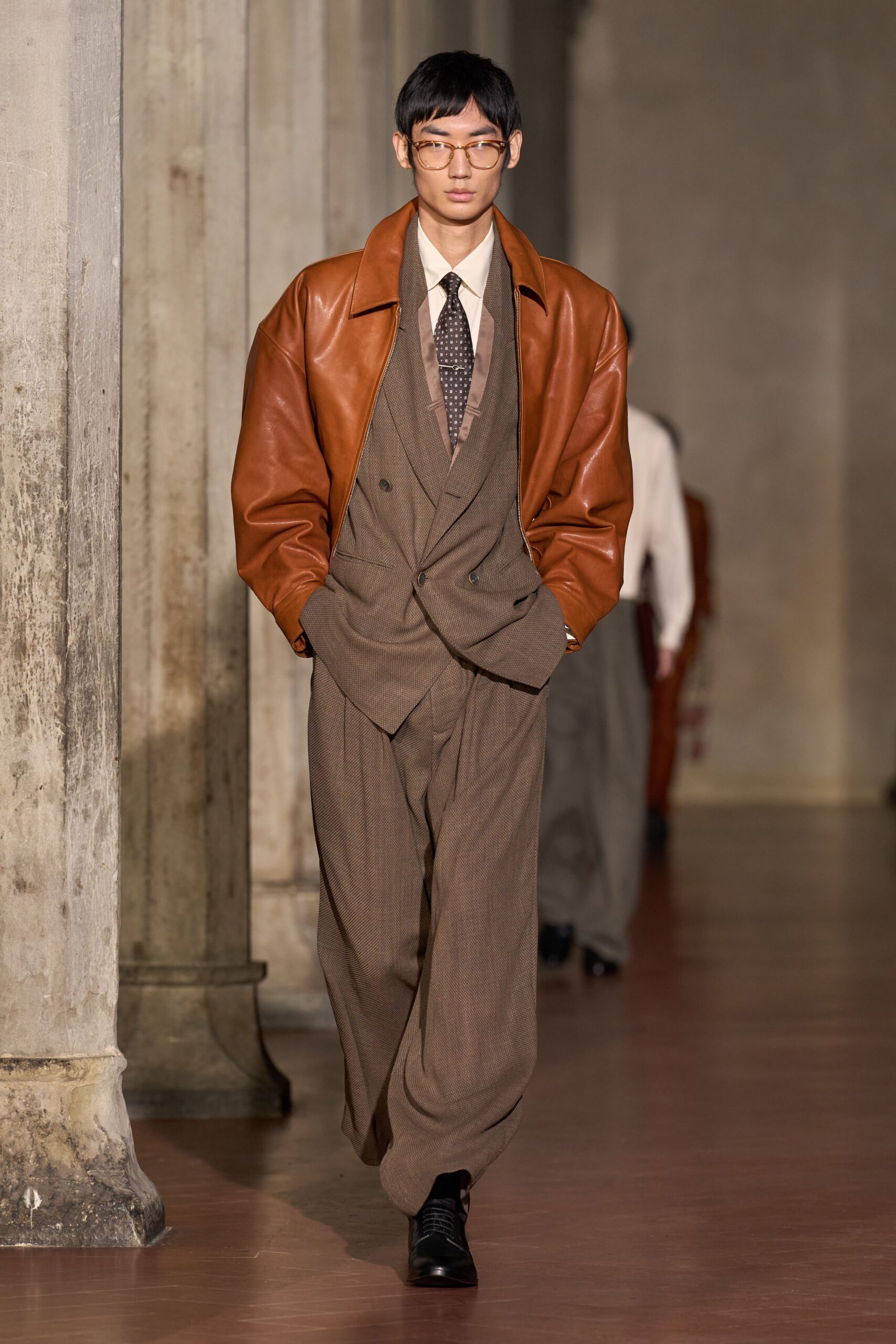 brown leather oversized jacket with gray suit