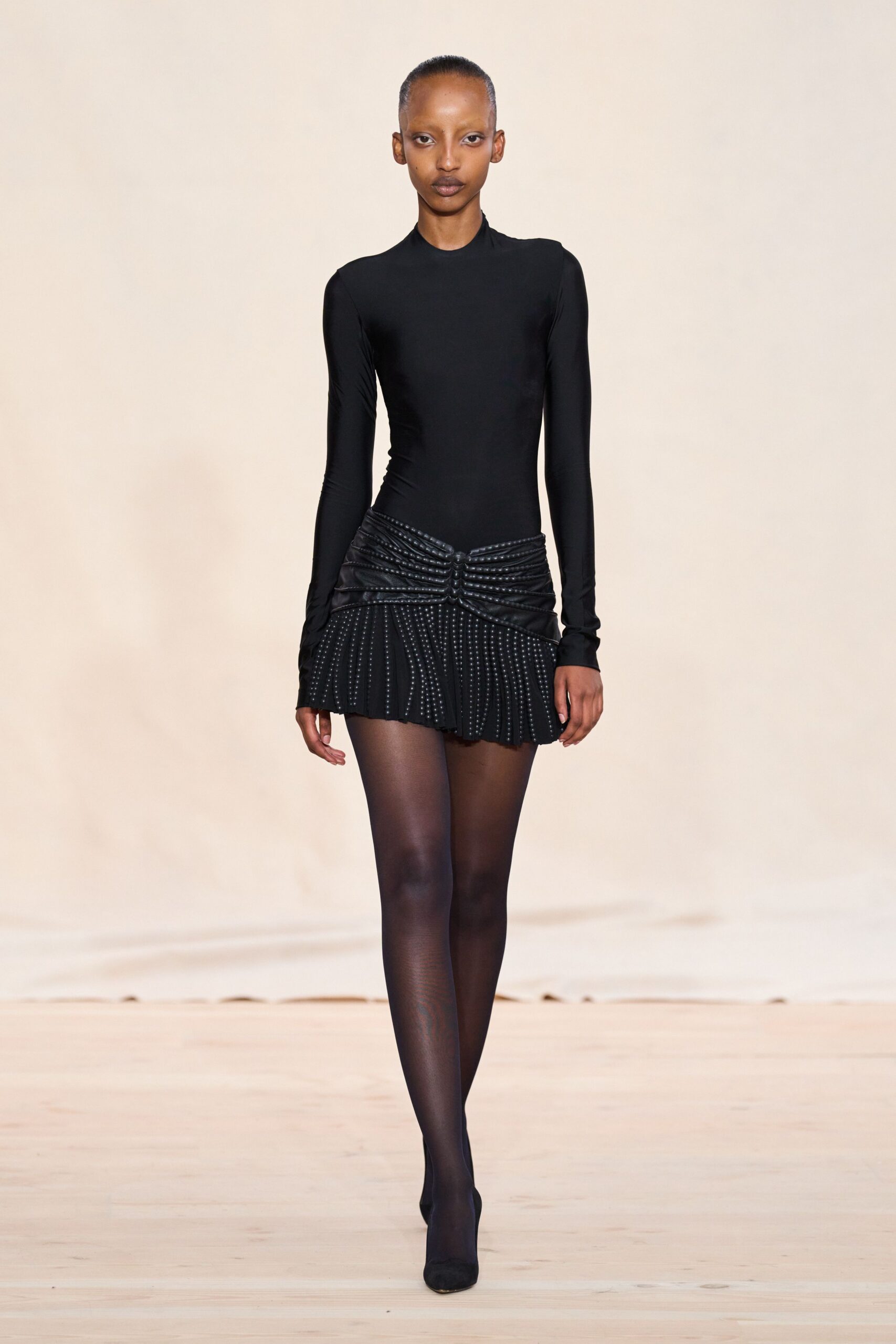 black fitted mini dress with pleats