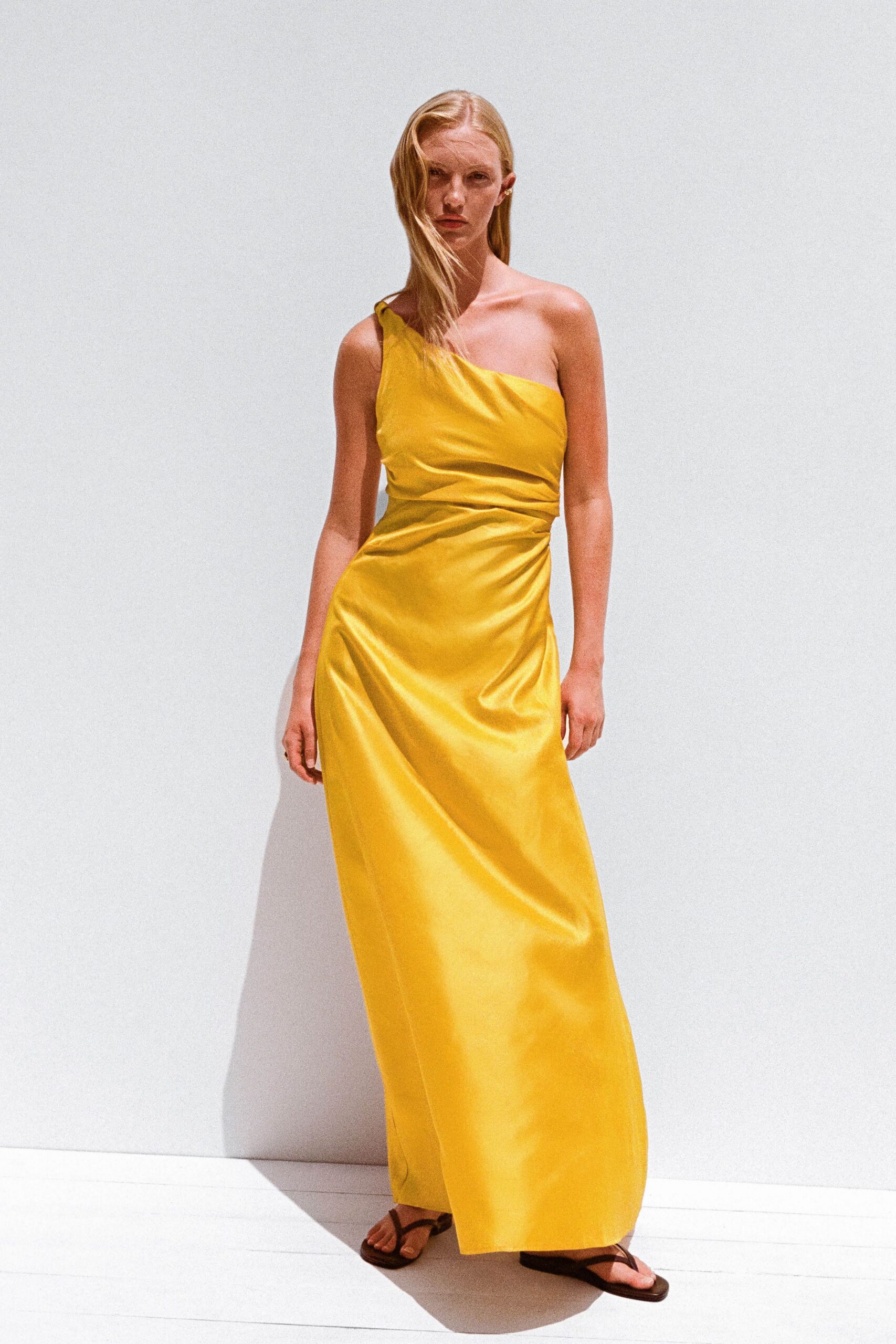 yellow silk sleeveless off-shoulder fitted draped shiny gown