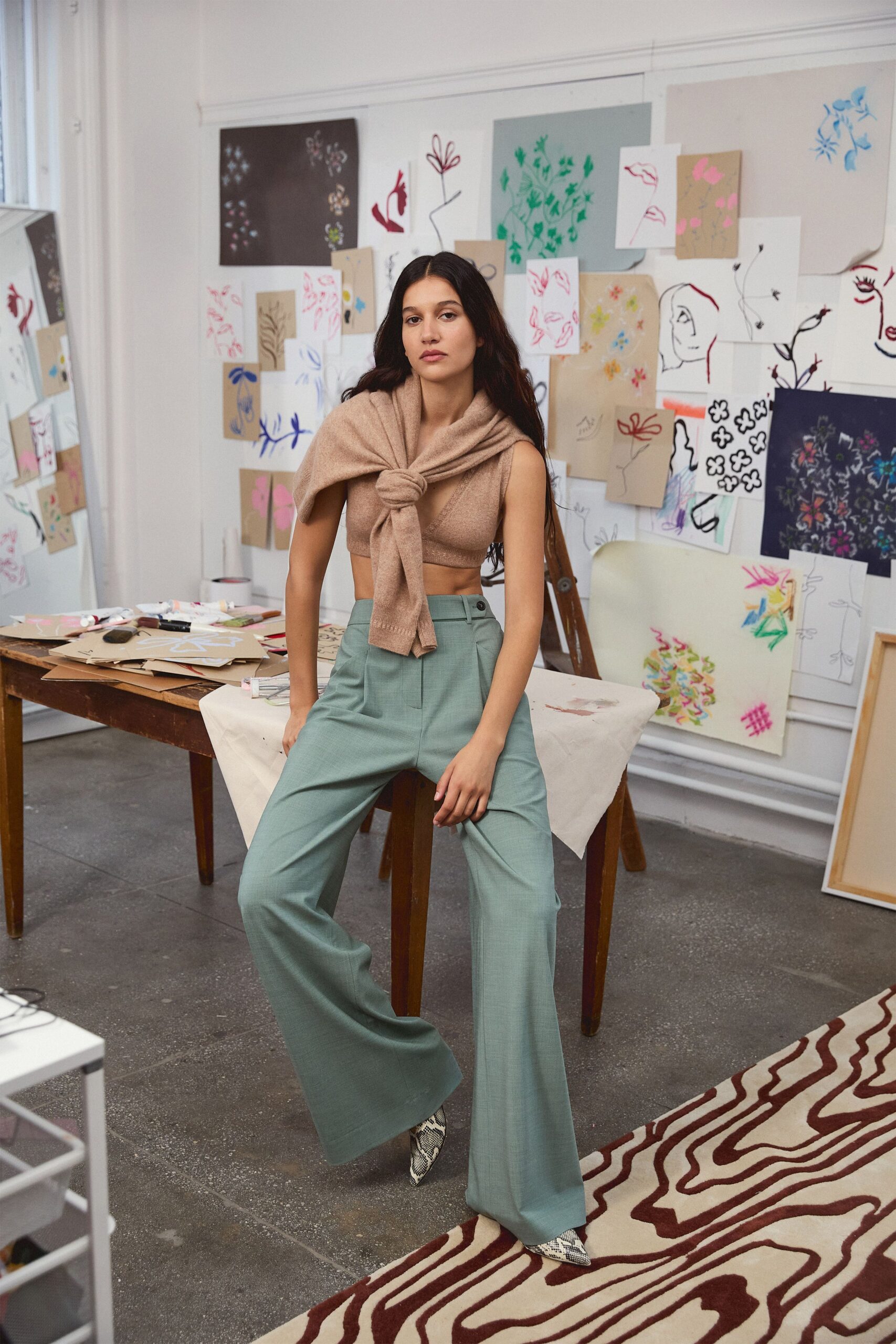 beige sleeveless top green wide-leg pants
