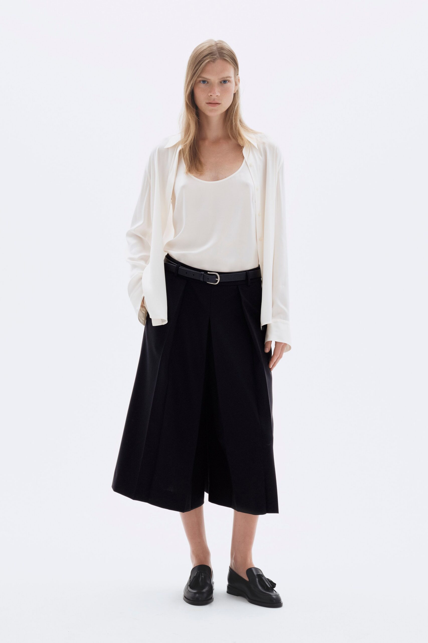 white relaxed top with black skirt