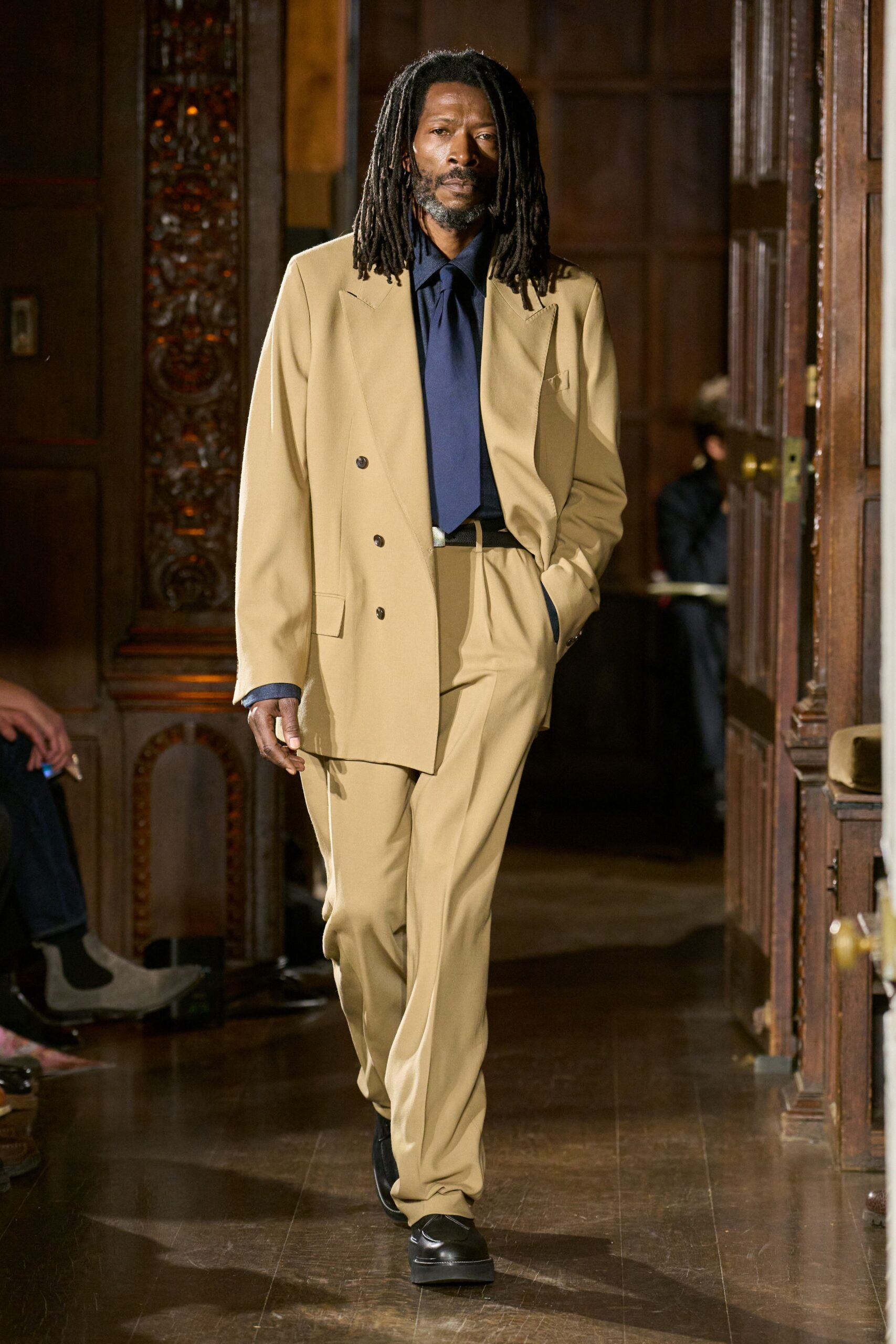 beige tailored suit with blue shirt