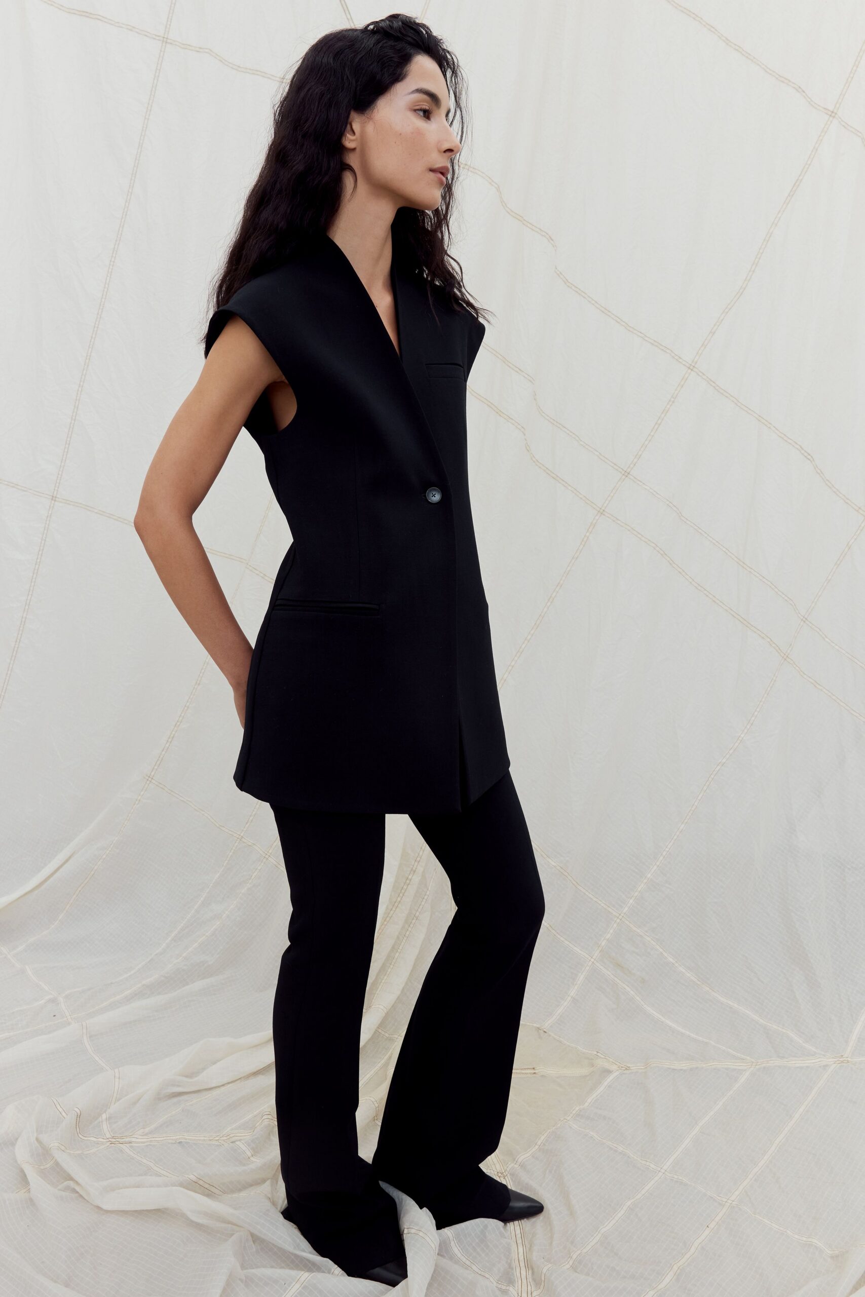 black wool sleeveless collared fitted buttoned blazer