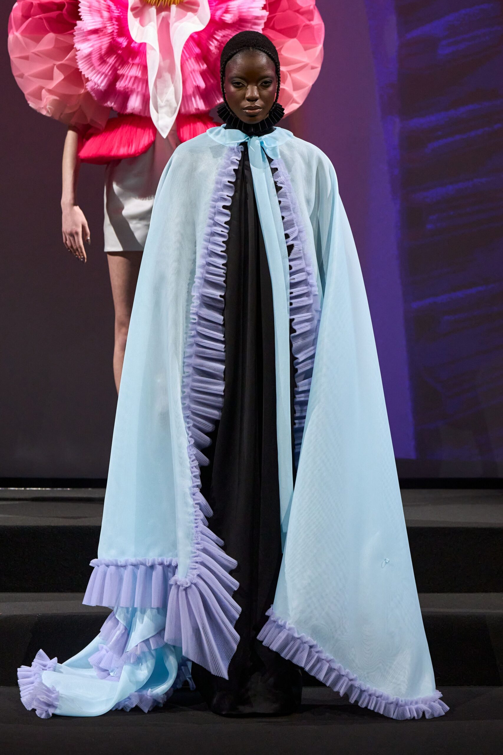 light blue ruffled cape over black dress