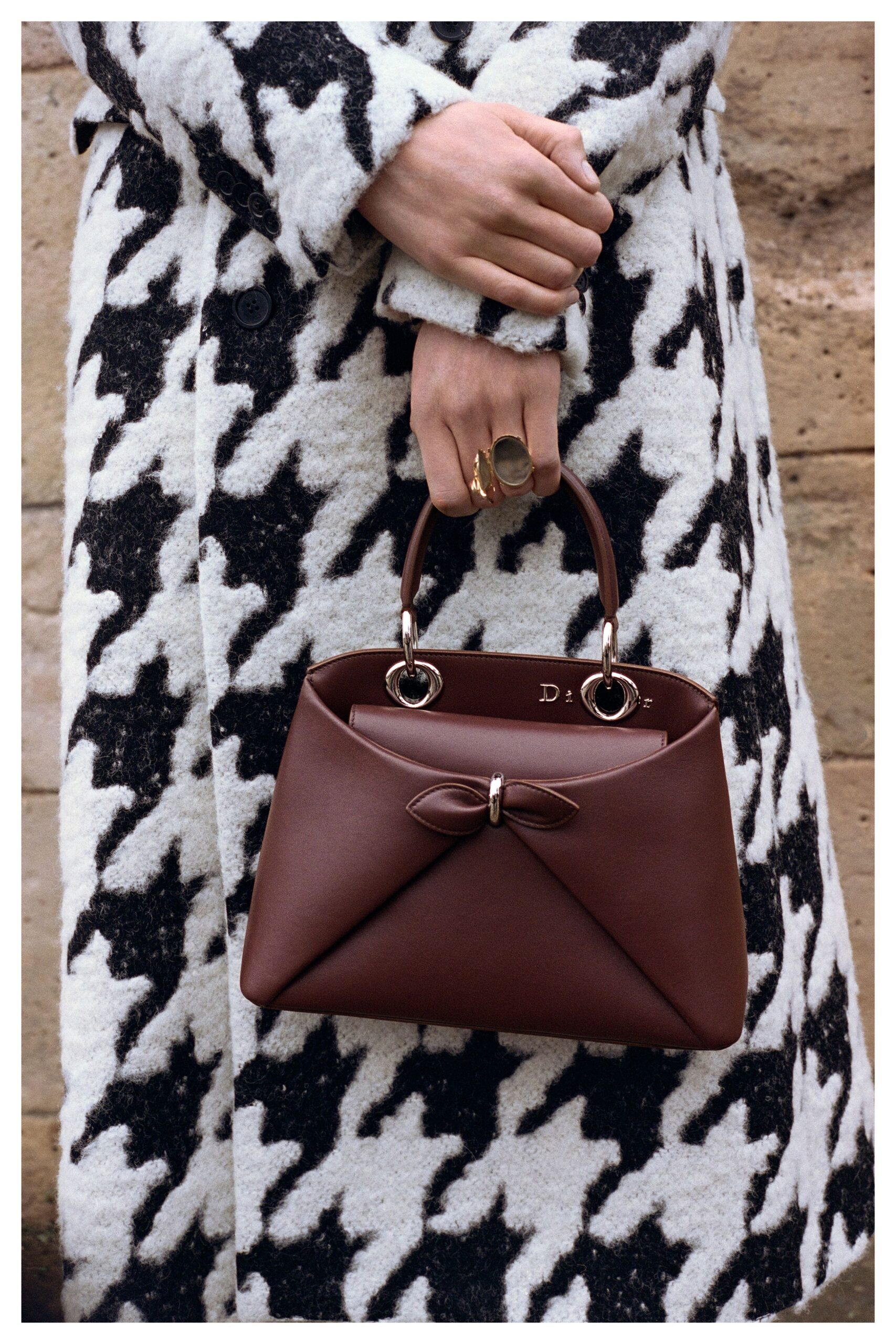 checked wool coat and brown bag