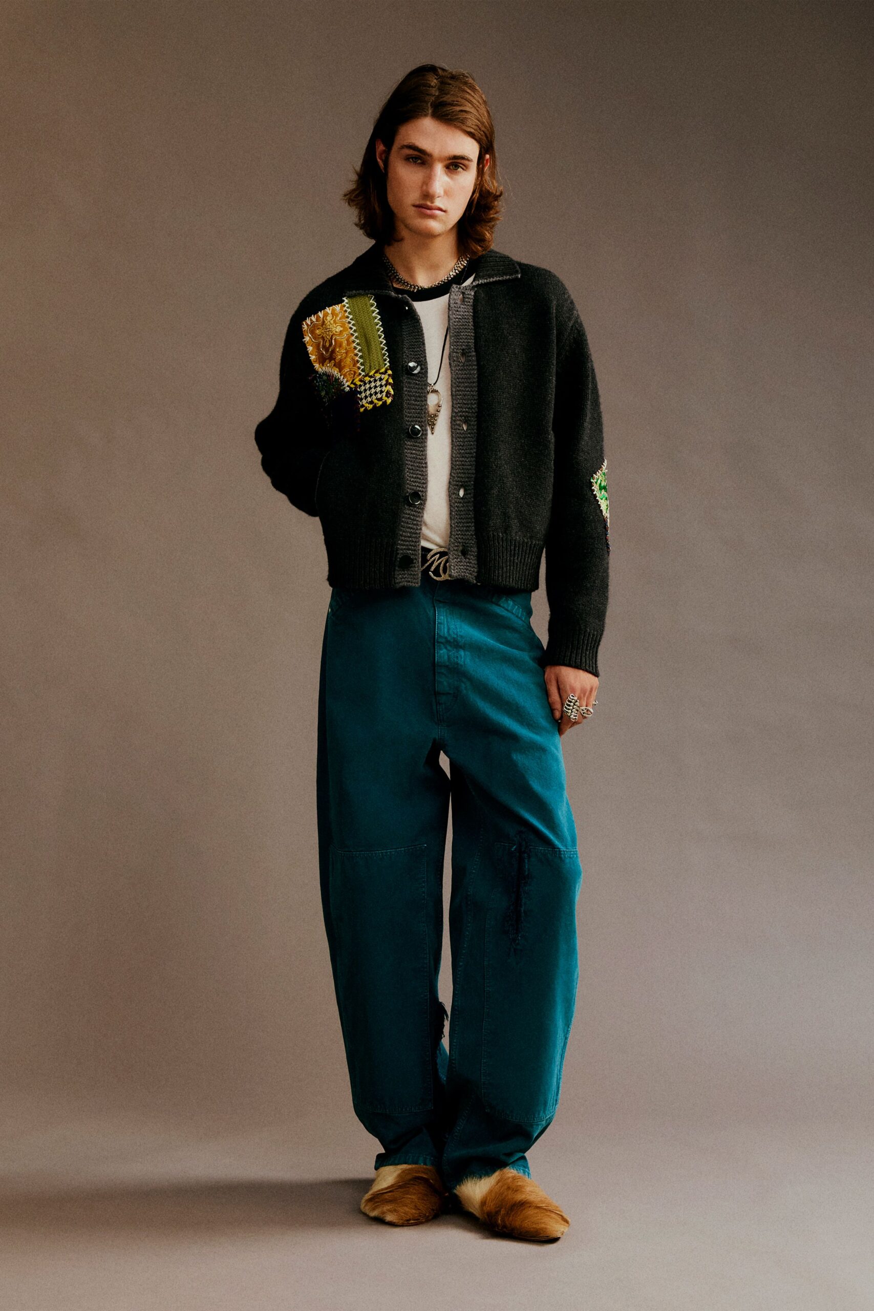 black cardigan gray t-shirt teal pants
