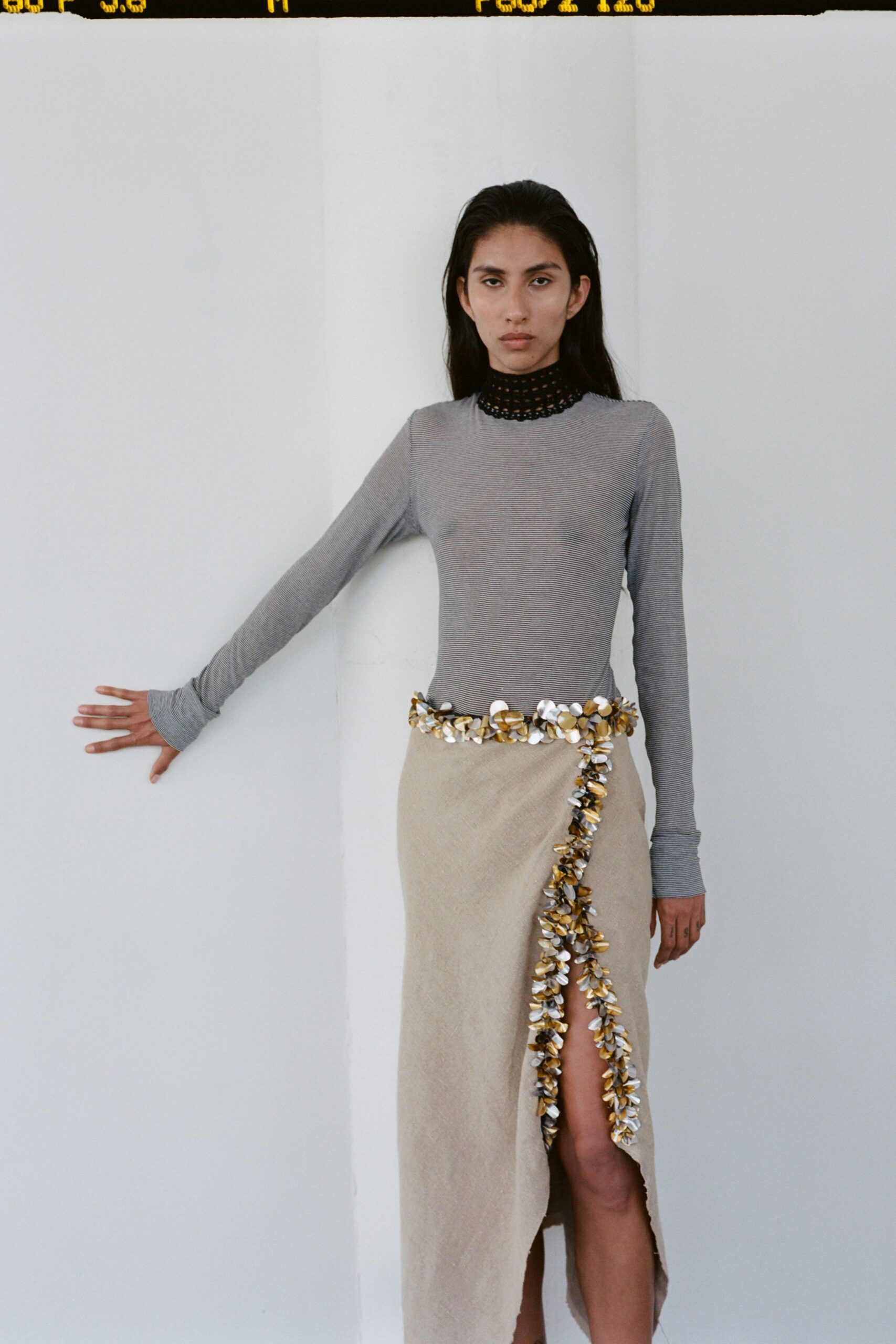 gray fitted top with beige skirt