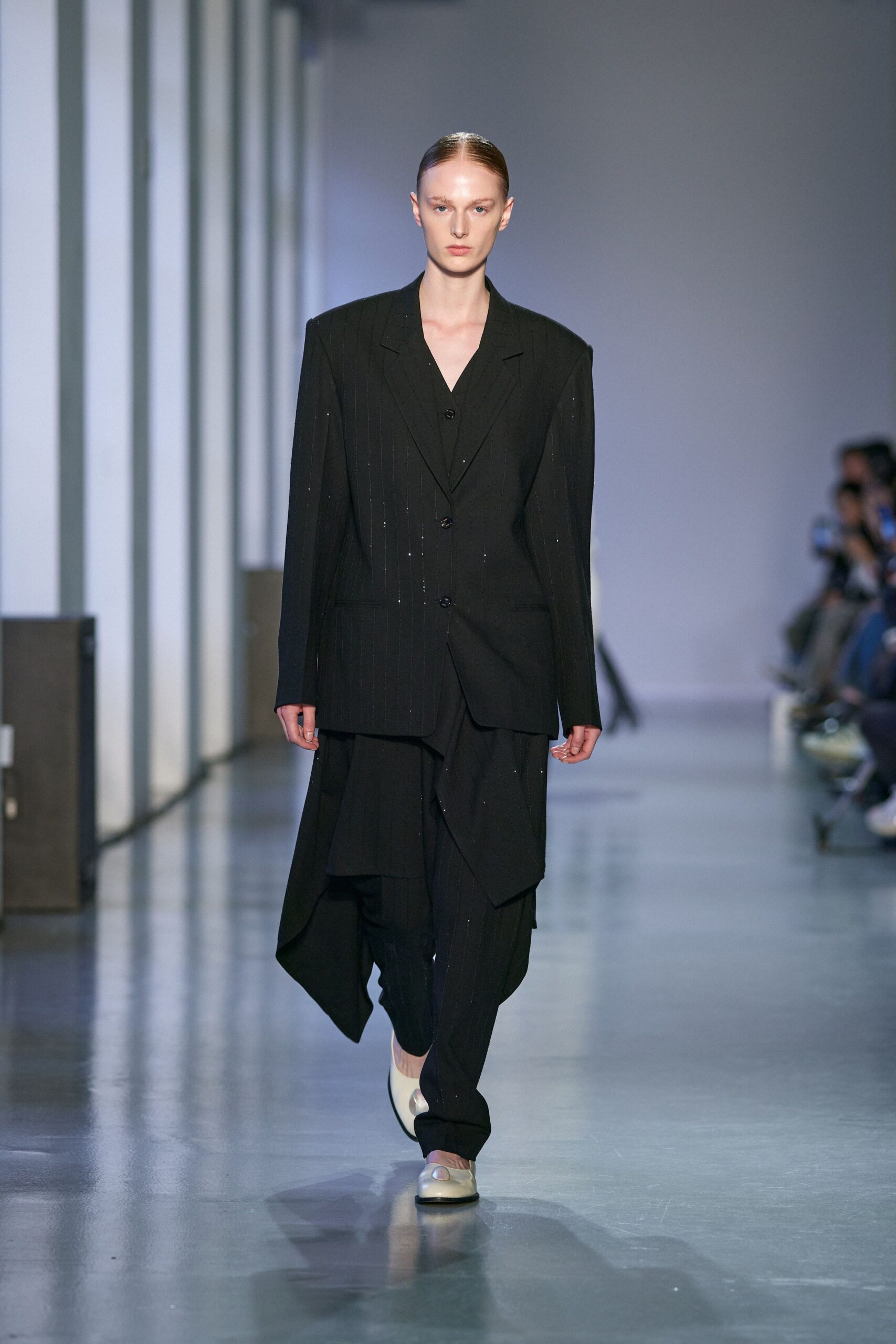 black wool relaxed suit with white shoes