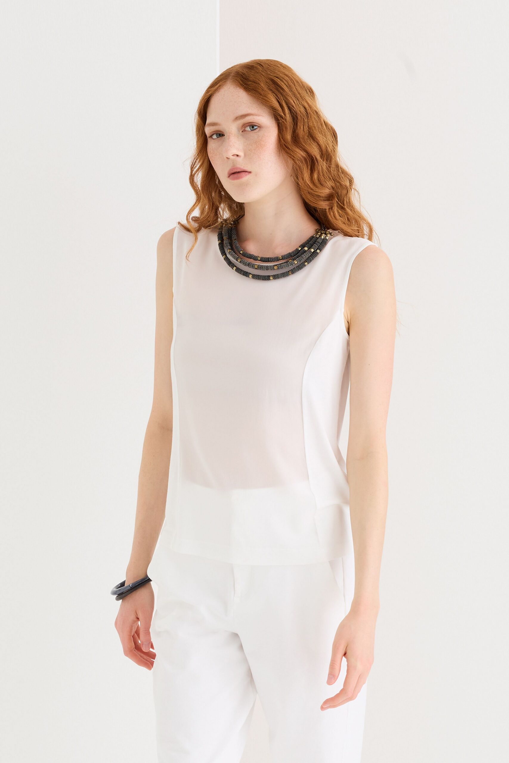 white sleeveless top and tailored pants