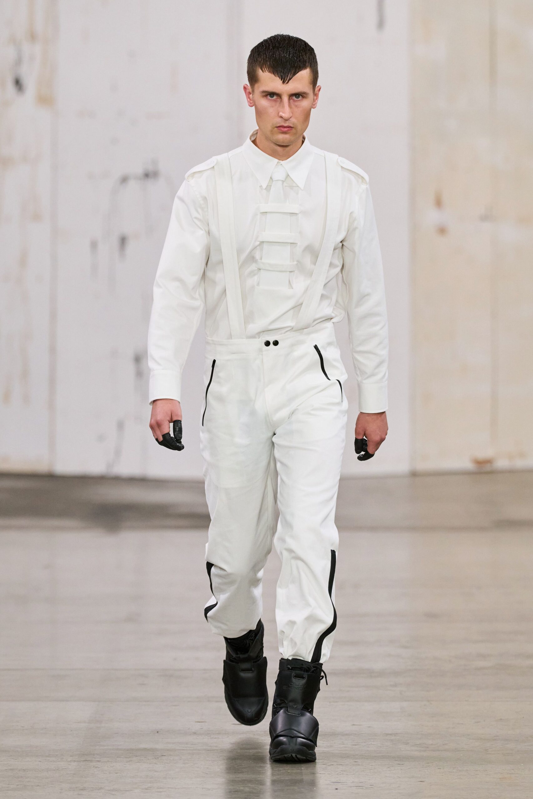white fitted jumpsuit with black boots