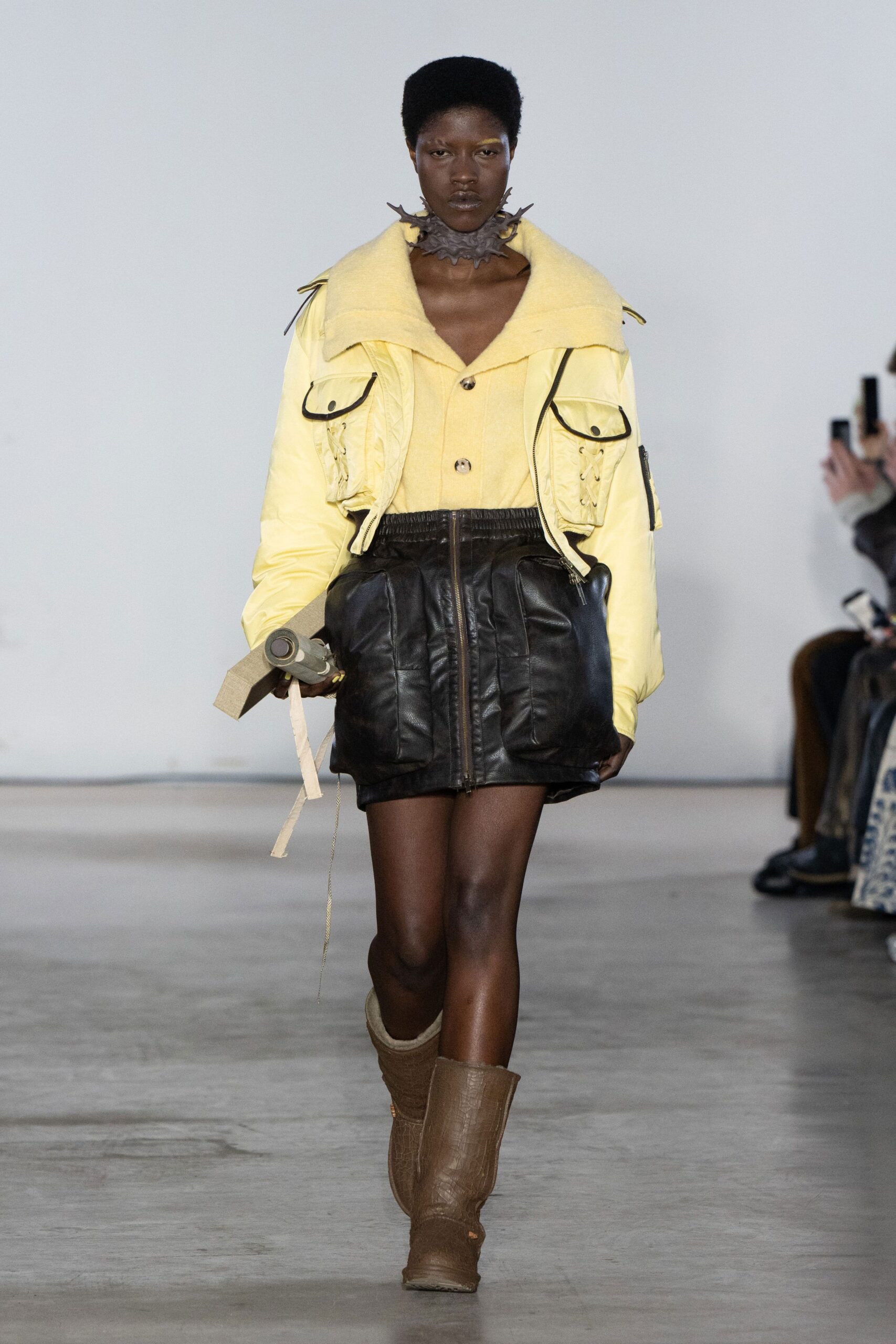 yellow jacket black skirt brown boots