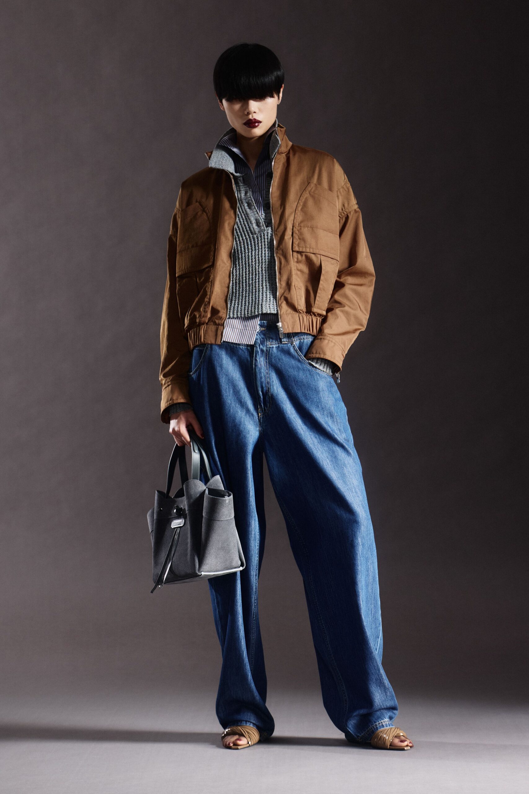 brown jacket gray top blue pants