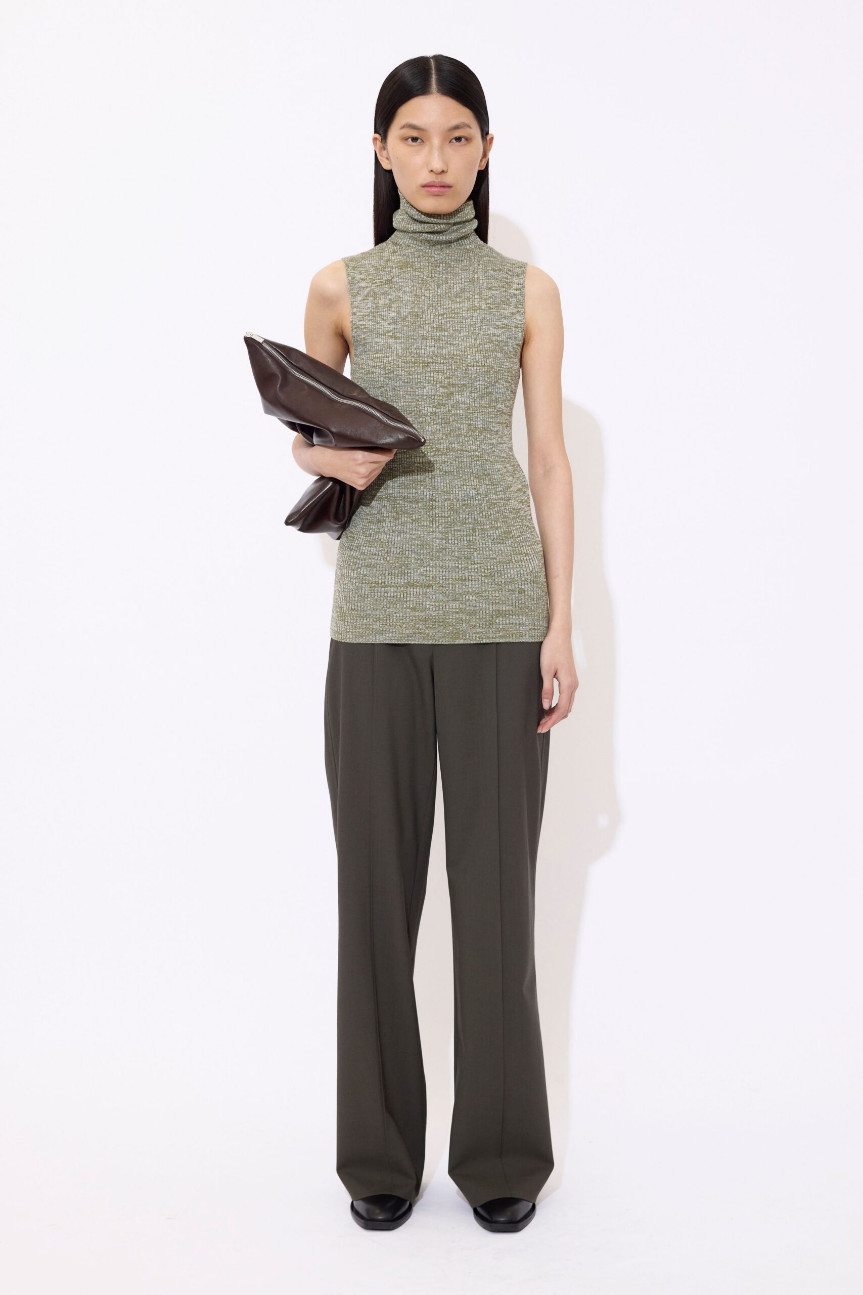 fitted green sleeveless top with gray pants