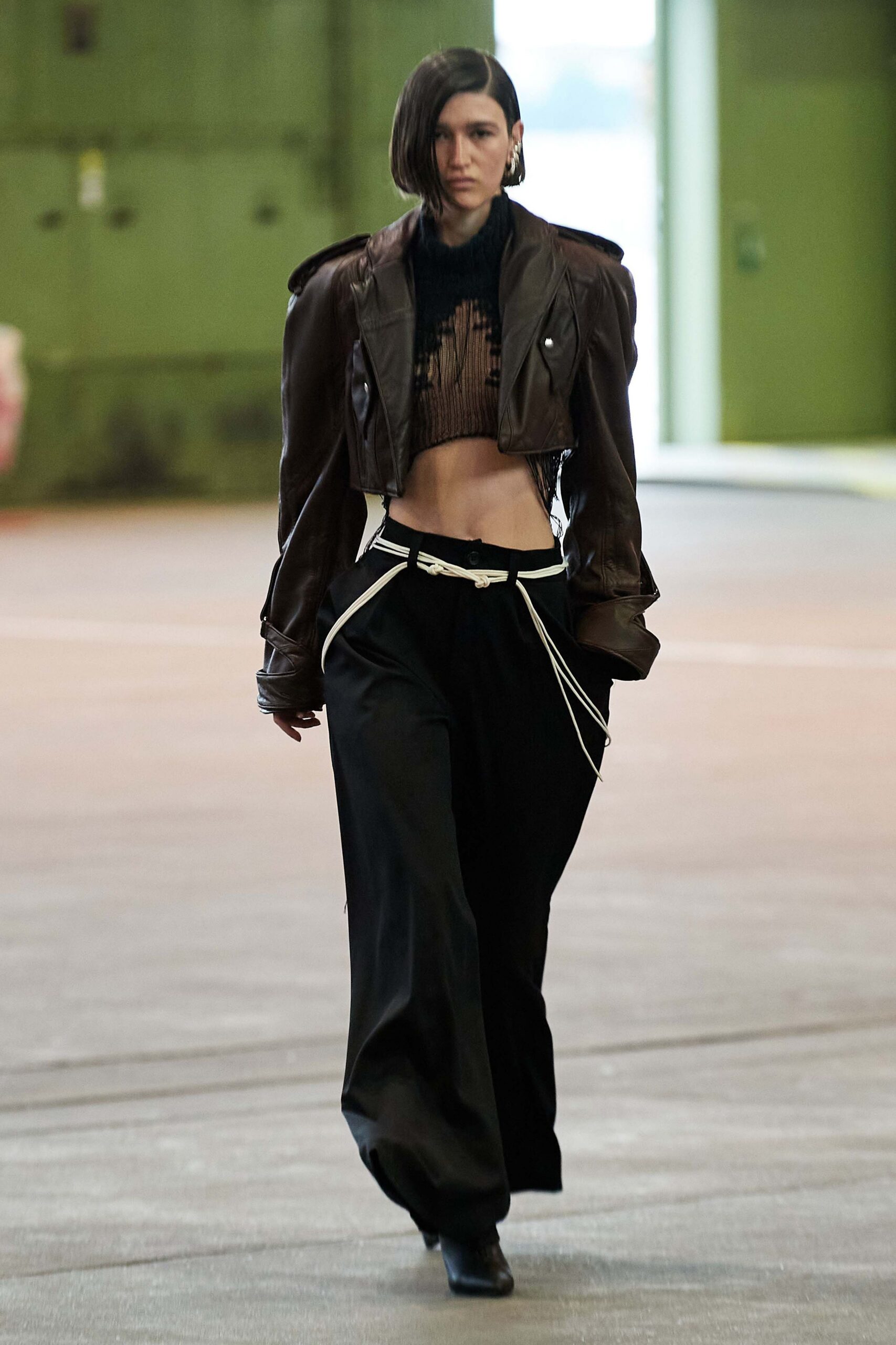 brown leather jacket with black top and pants