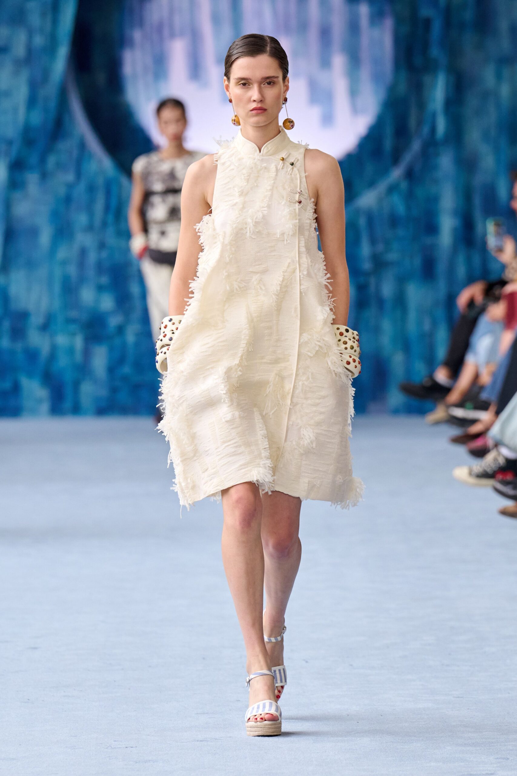 white ruffled mini dress with strappy shoes