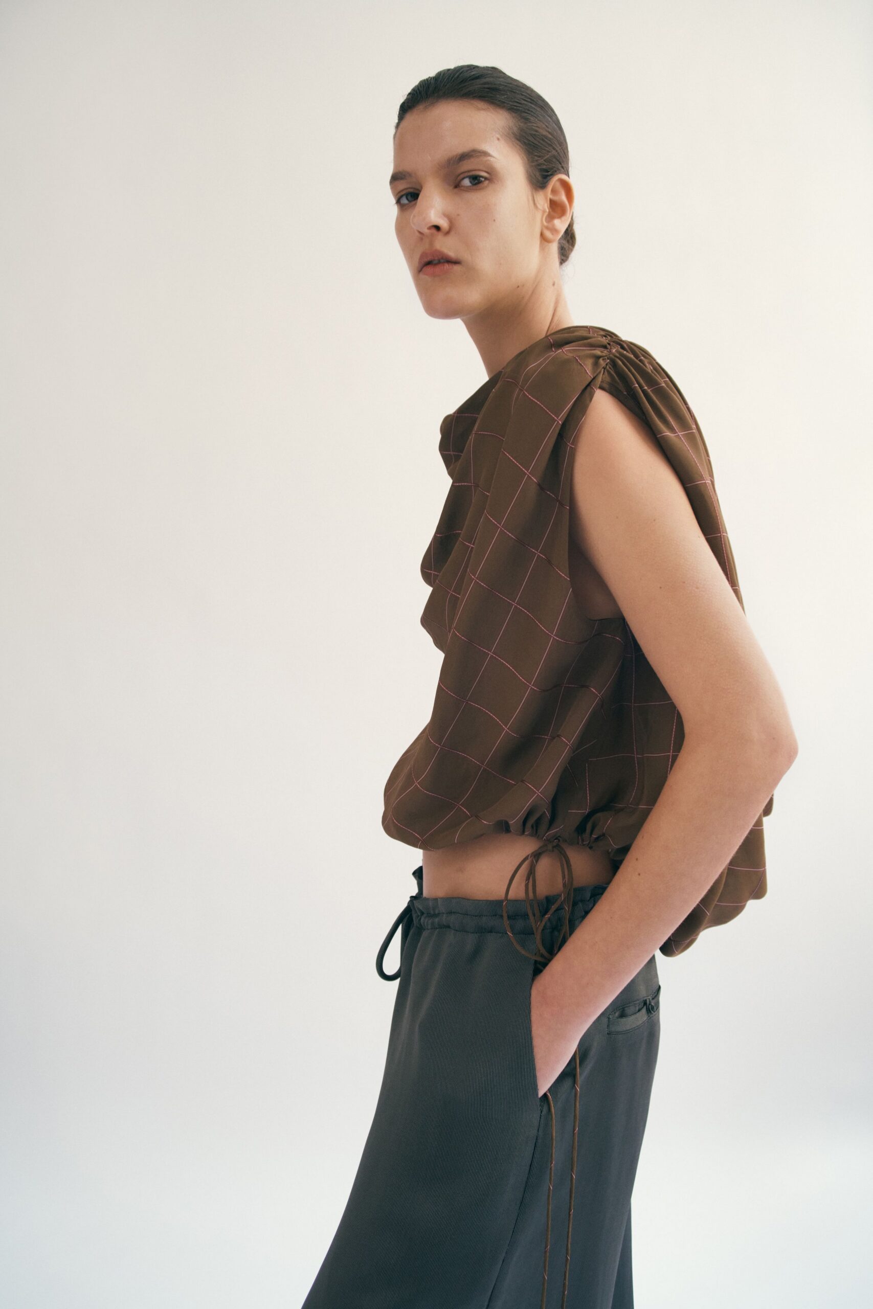 brown checked top with gray pants
