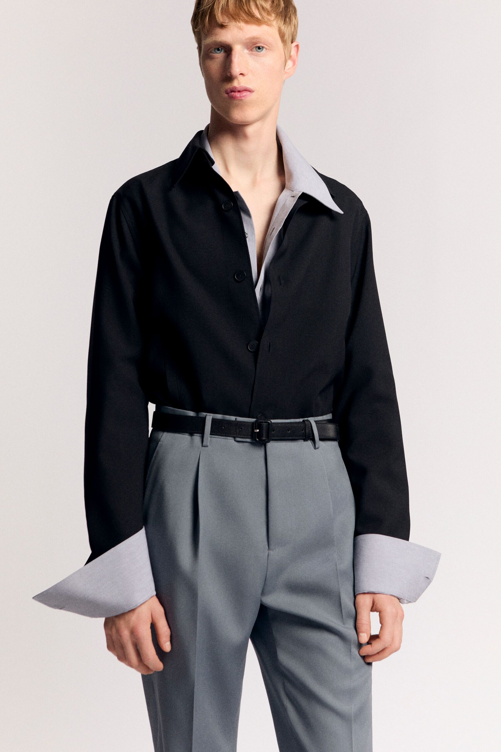 black shirt gray tailored pants