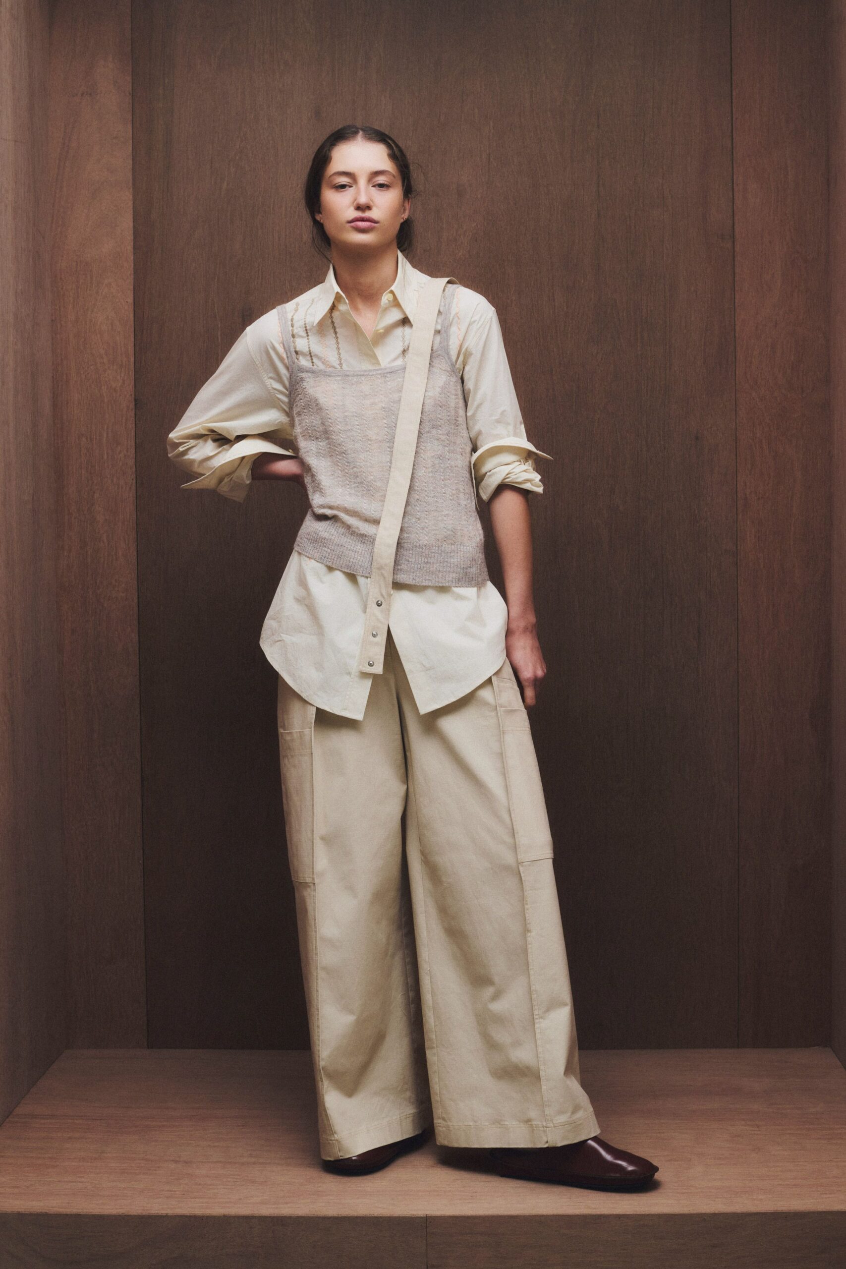 white shirt gray vest beige pants