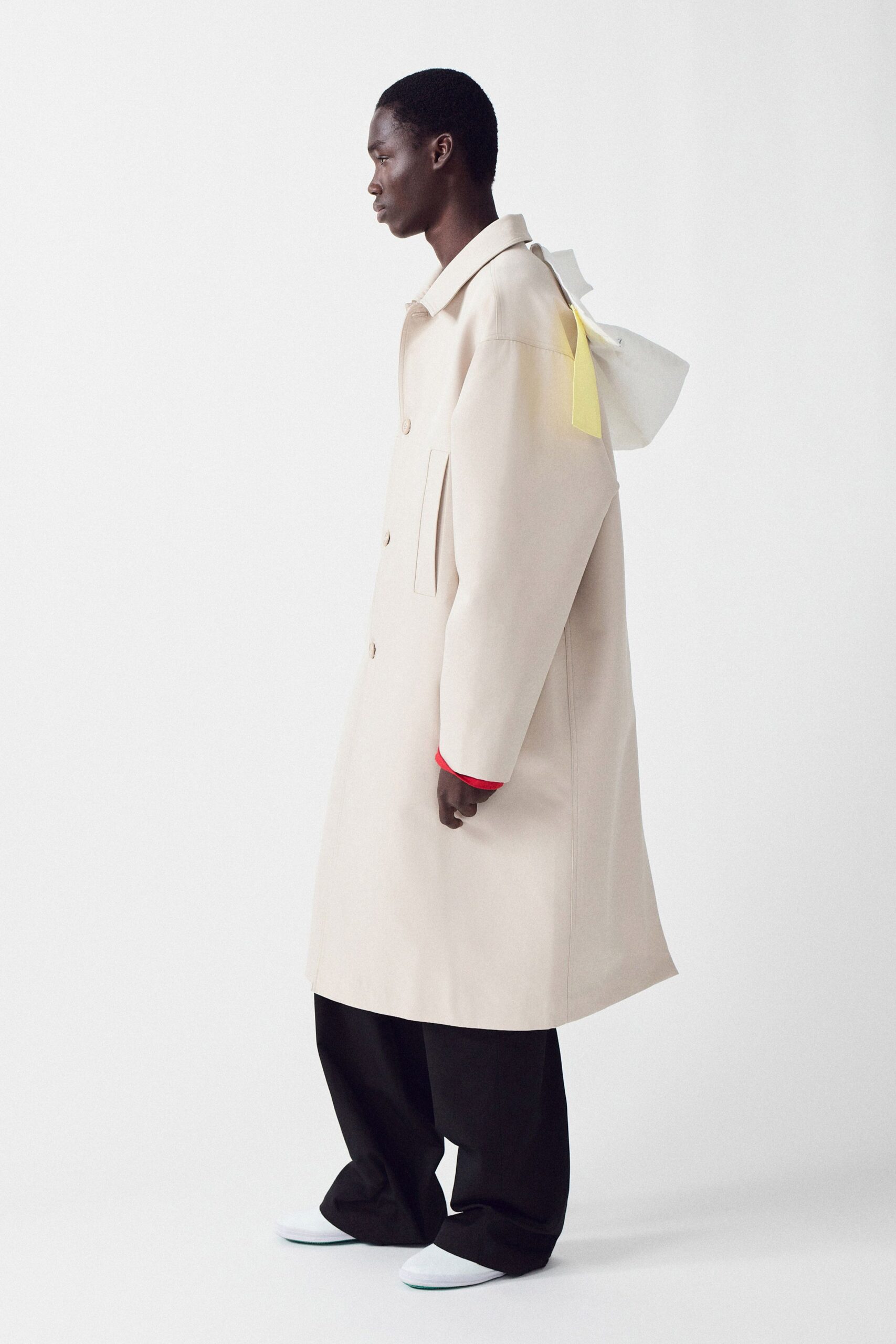 beige coat black pants white shoes