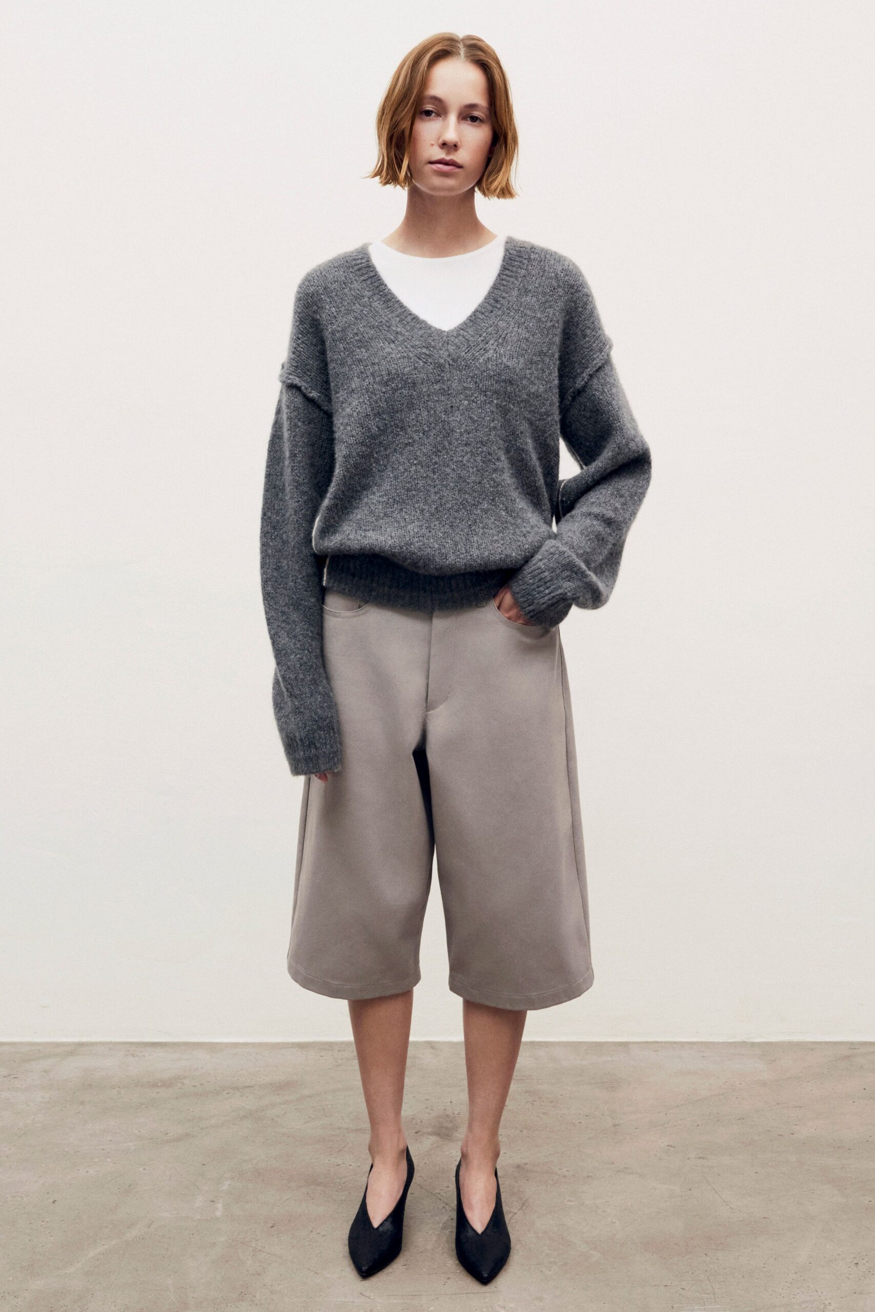gray relaxed sweater with beige shorts