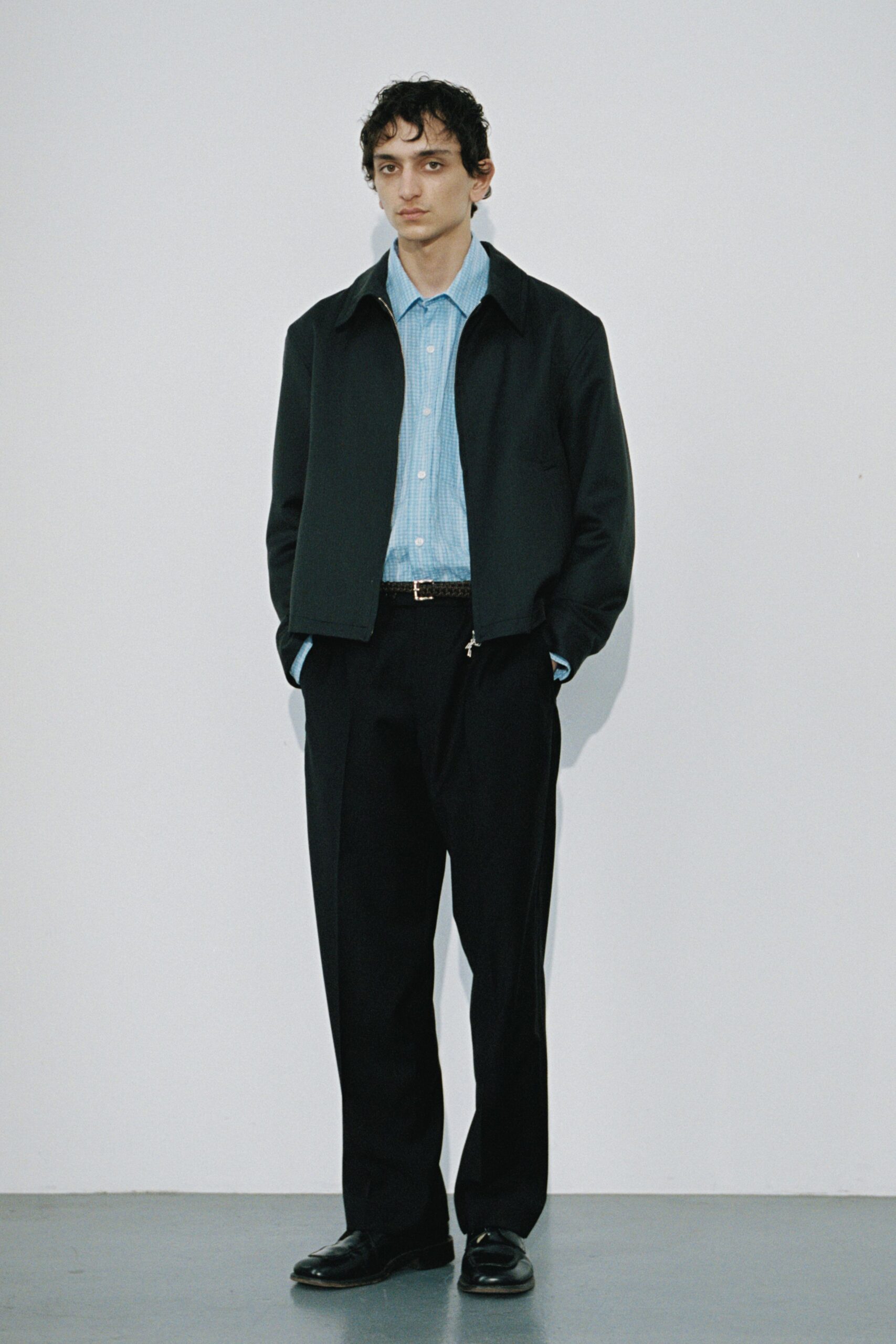 black jacket blue shirt black pants