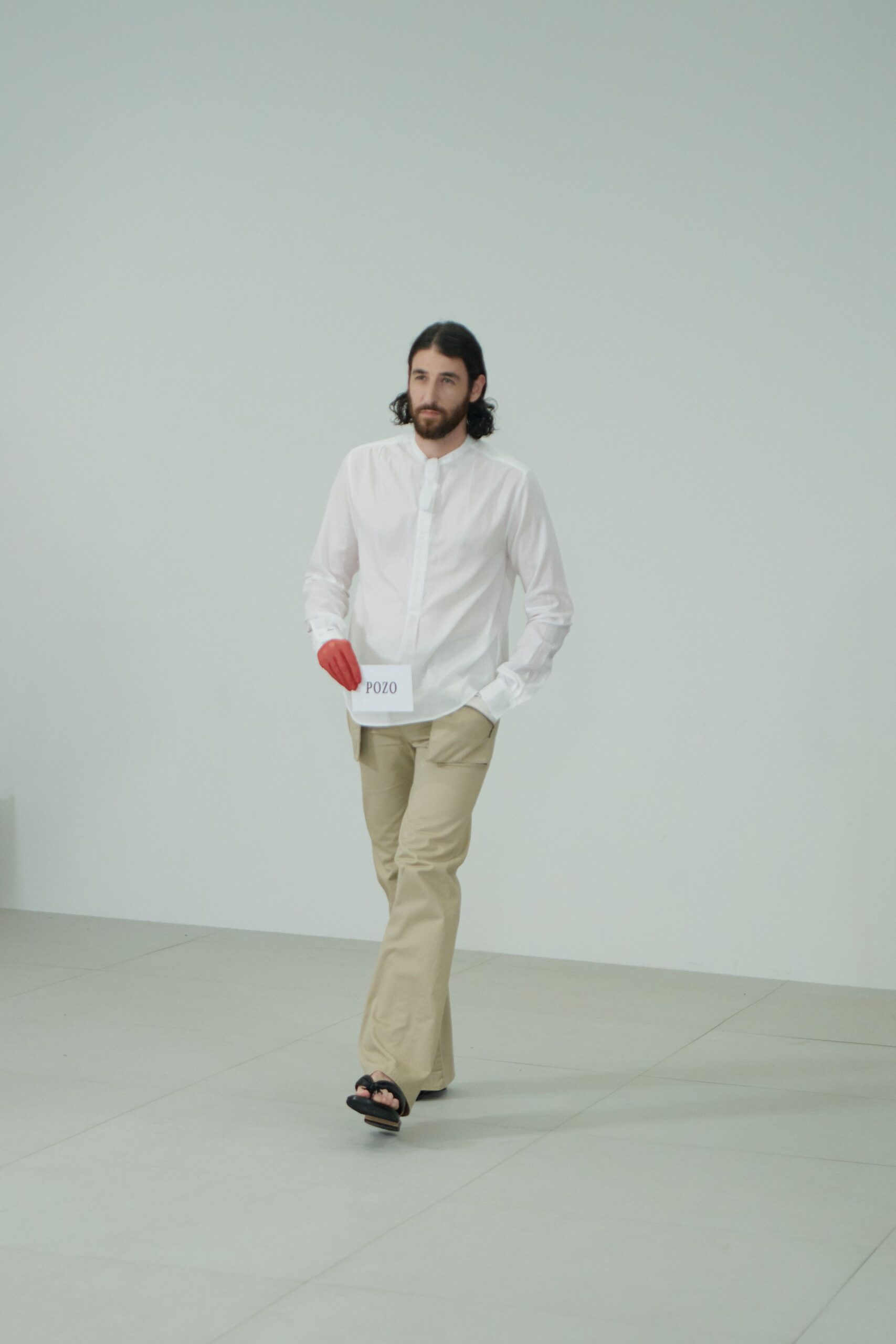 white shirt beige pants black shoes red gloves