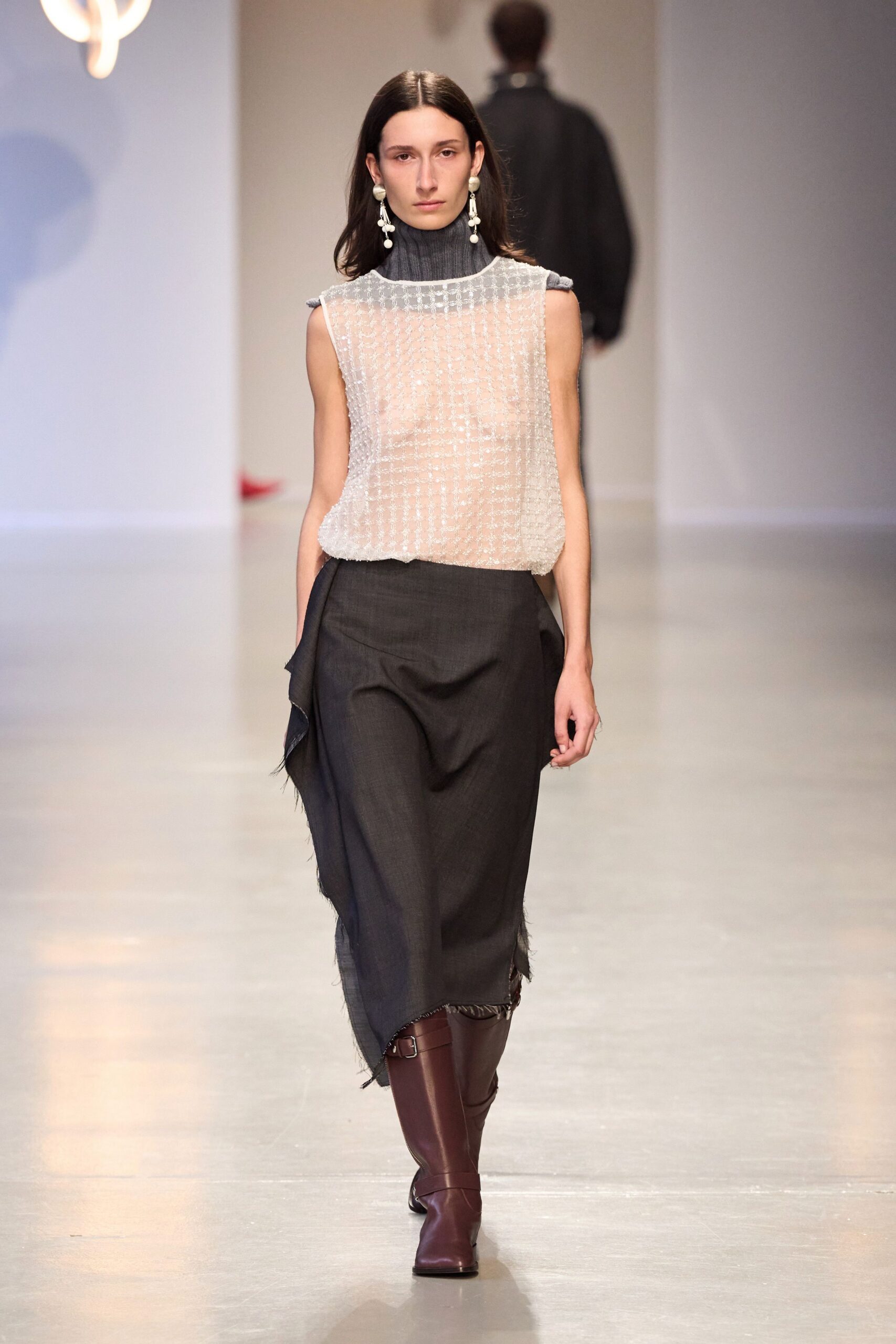 white pleated sleeveless top with black skirt