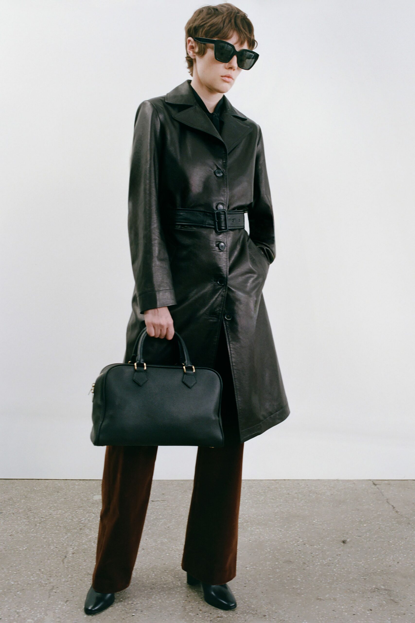 black leather coat with brown pants