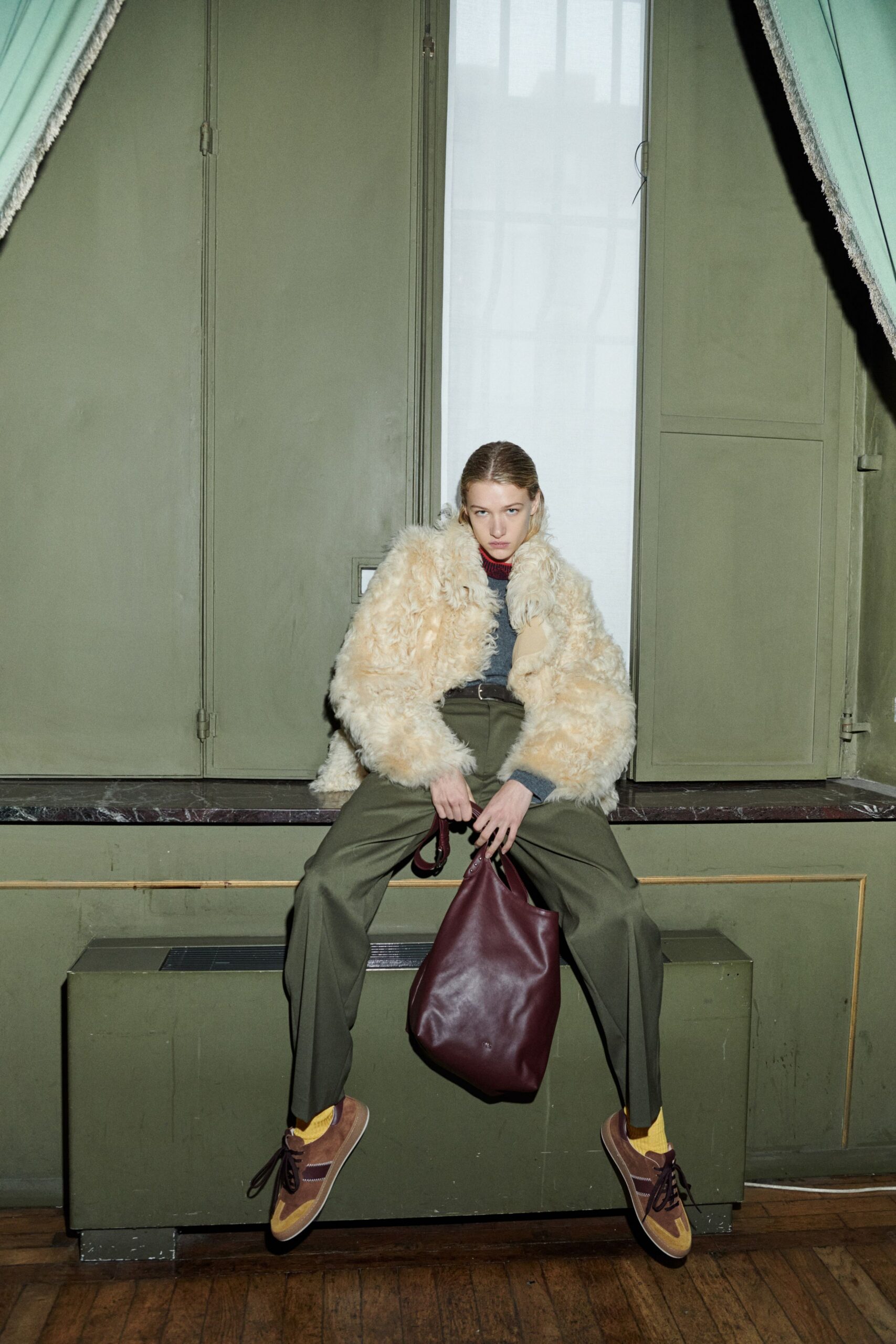 beige faux-fur coat with green pants