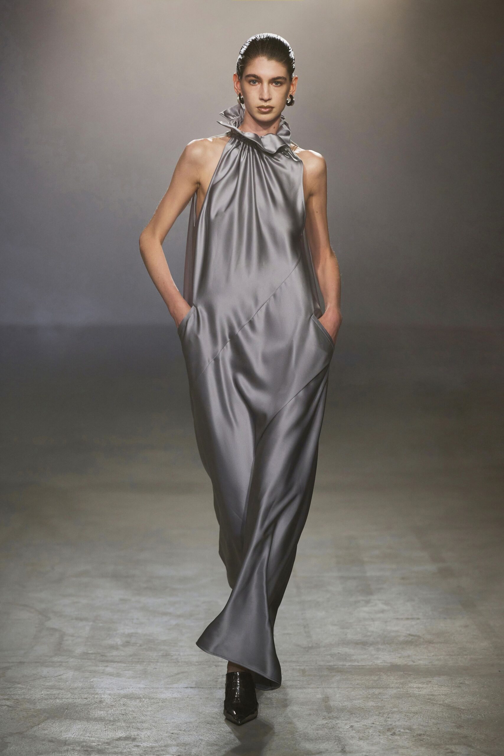 gray silk sleeveless high-neck fitted draped pockets gown