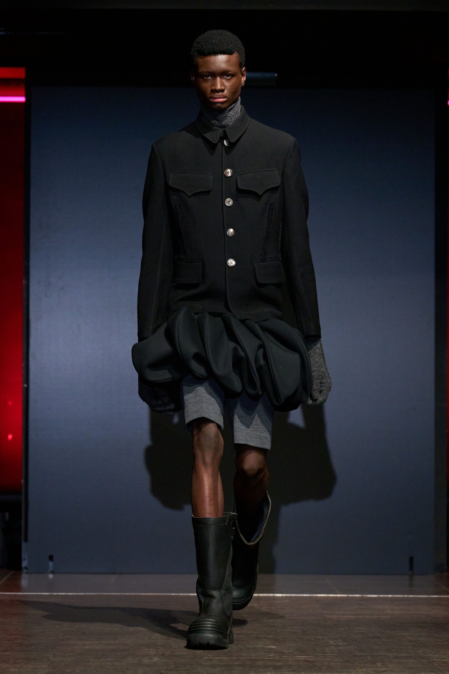 black jacket gray shorts black boots