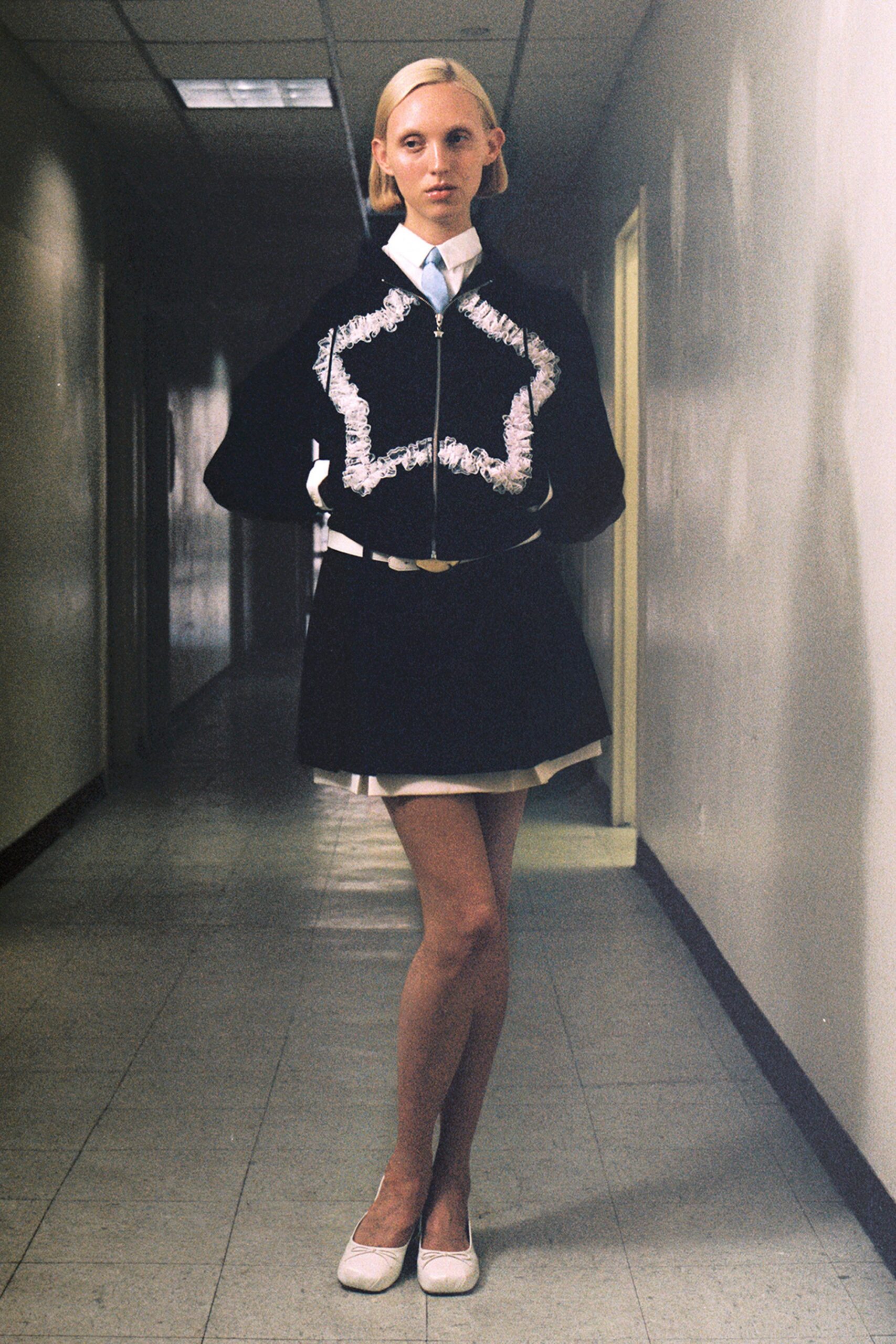 black fitted jacket and mini skirt