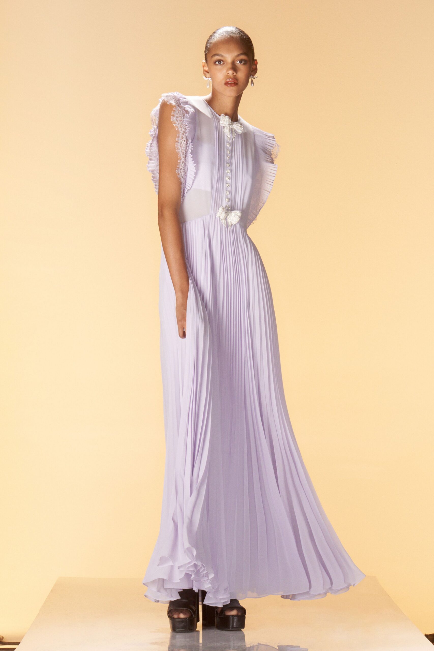 lavender pleated gown with black shoes