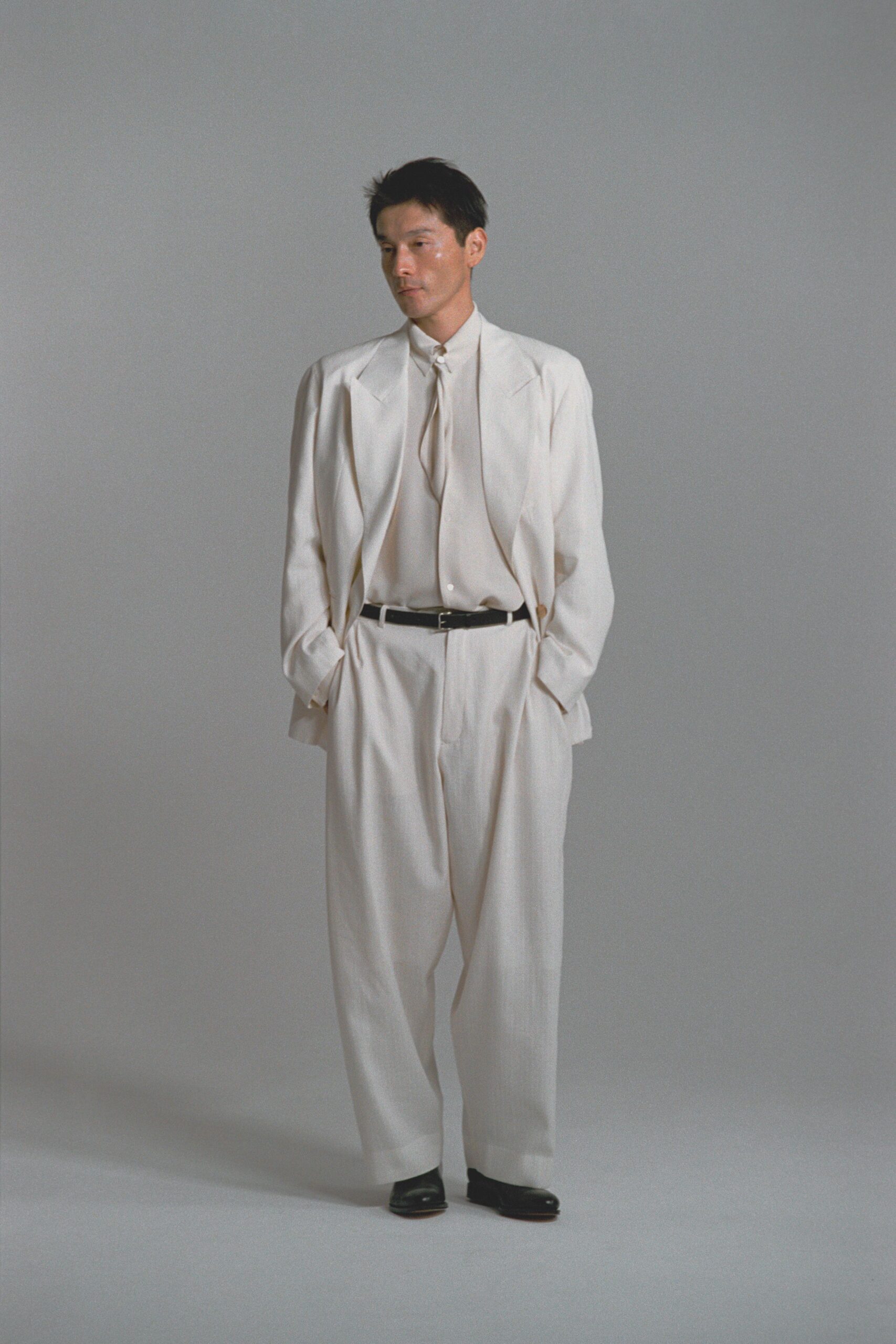 white relaxed suit with black shoes