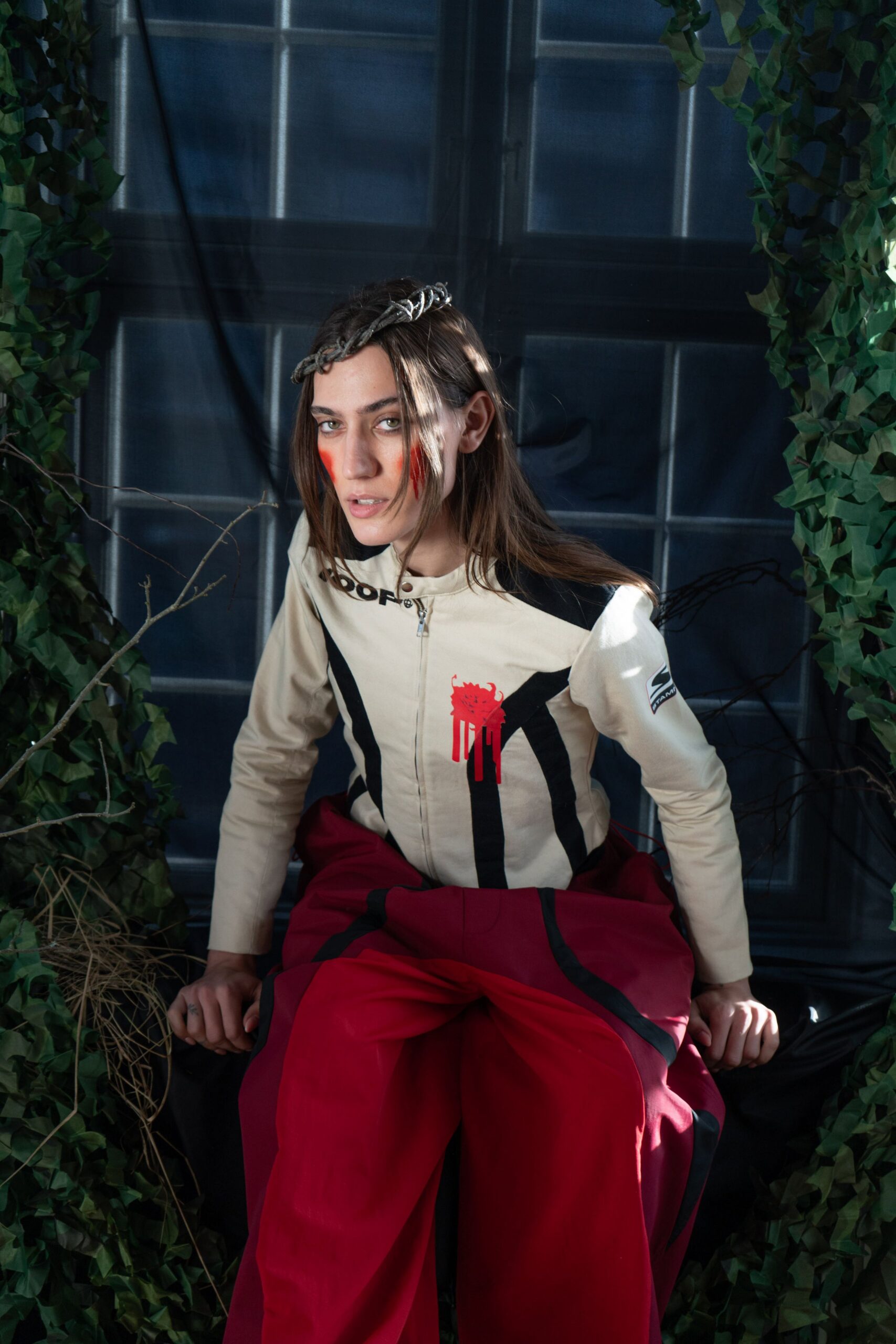 beige fitted jacket and red relaxed pants