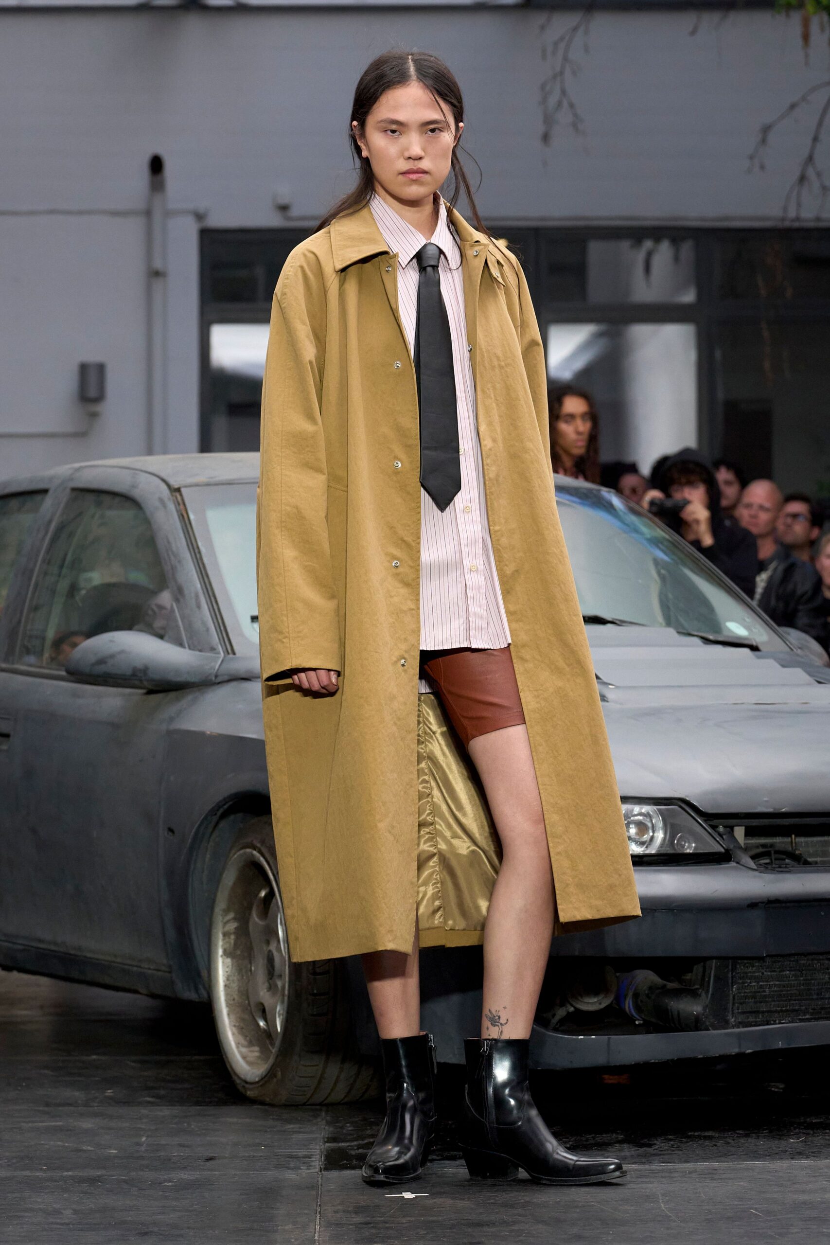beige coat with brown leather shorts