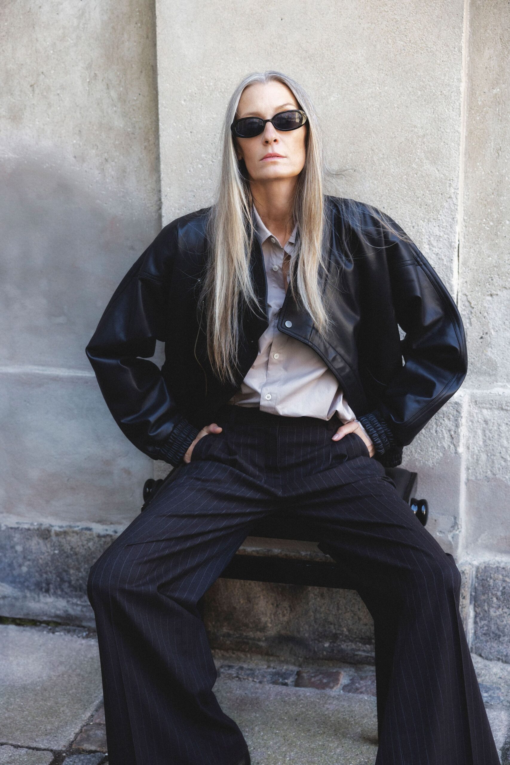 black leather jacket with beige shirt
