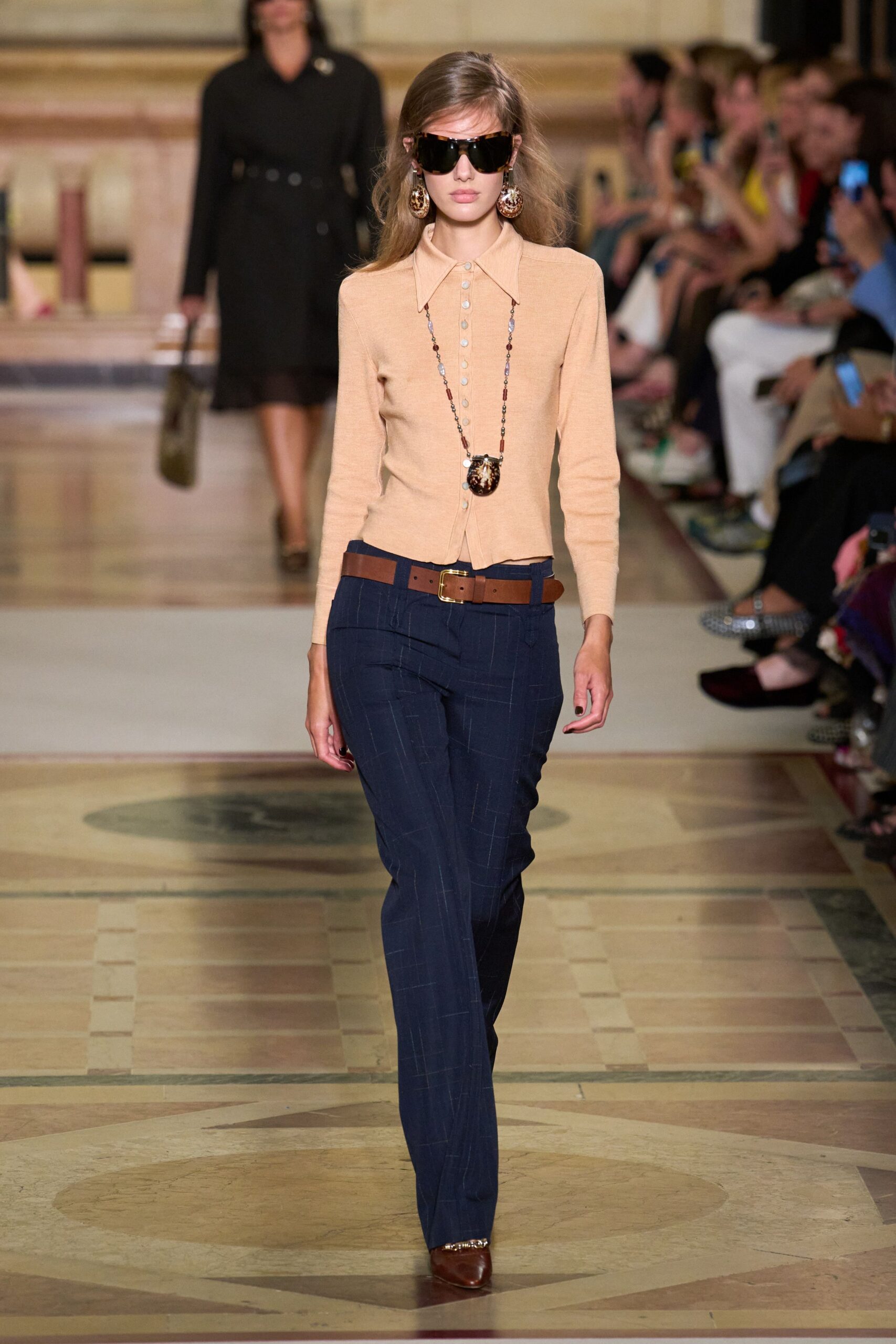 beige fitted top with blue tailored pants