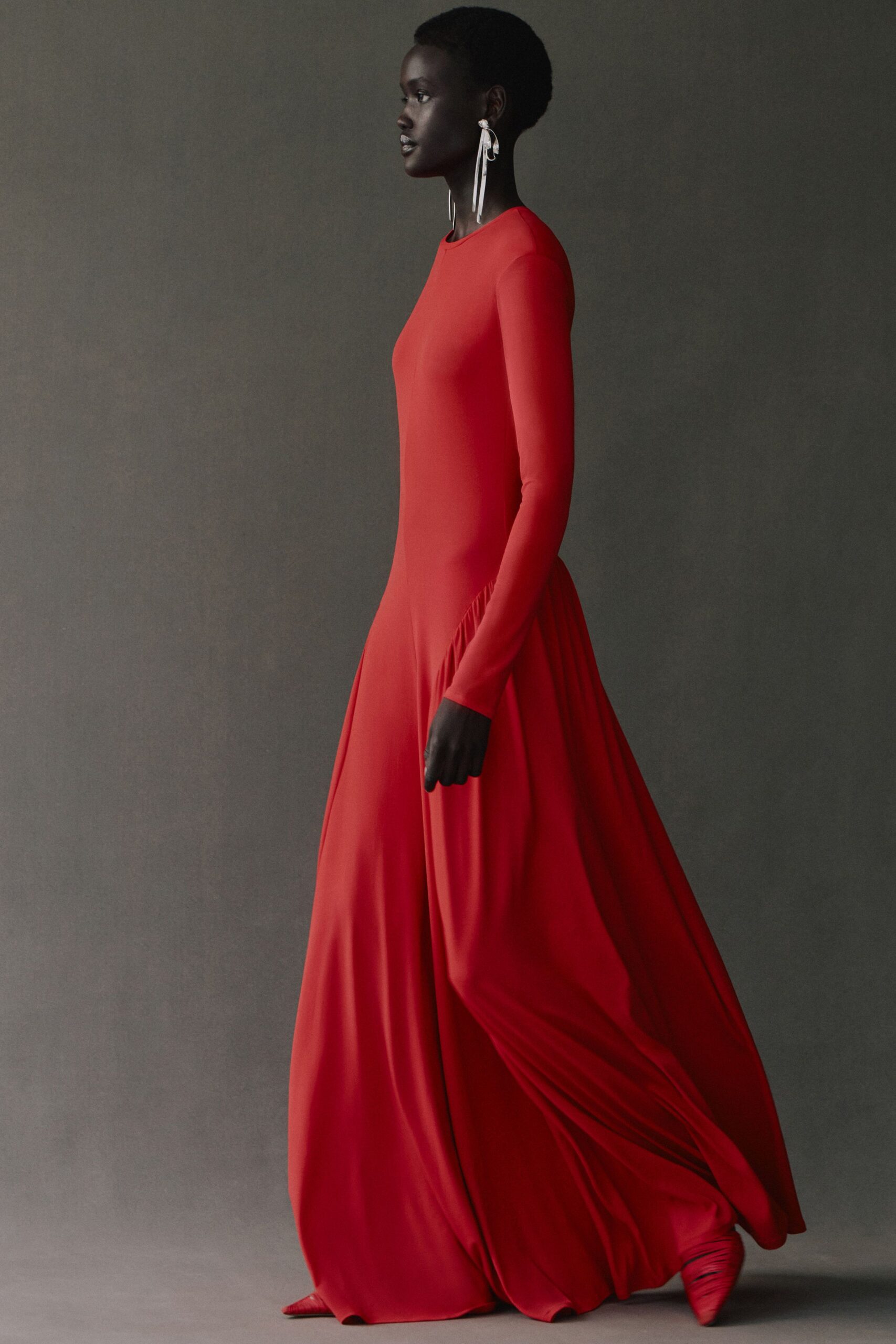 red silk long-sleeve high-neck fitted draped flowing gown