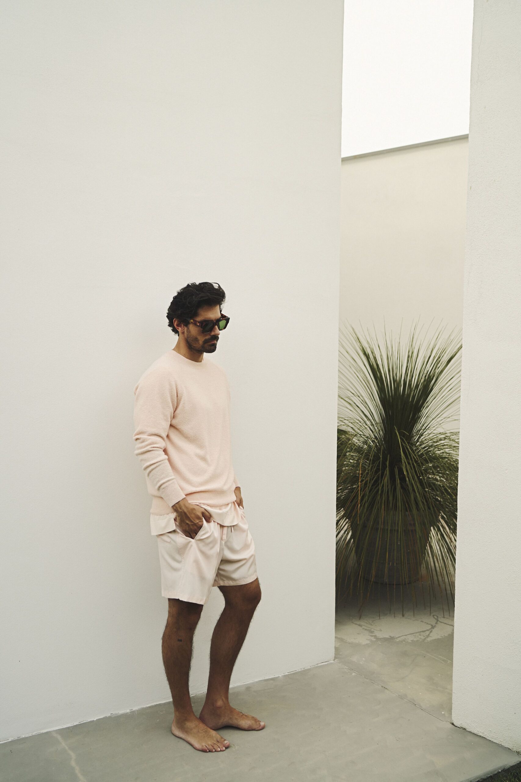 pink relaxed sweater with beige shorts