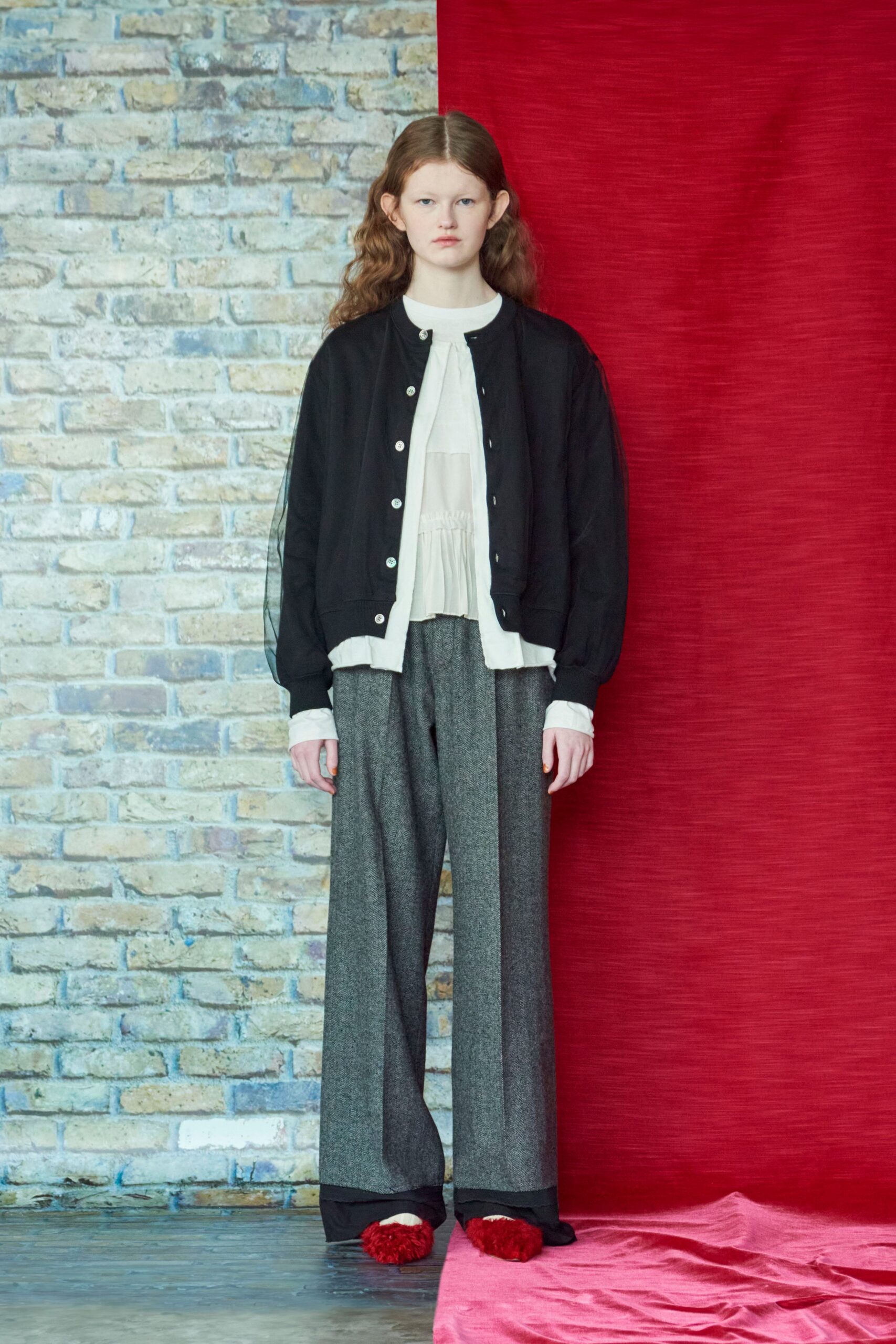 black jacket white blouse gray pants red shoes