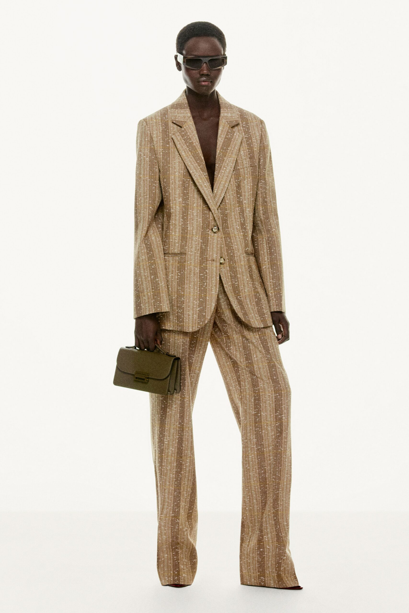 beige tailored suit with sunglasses